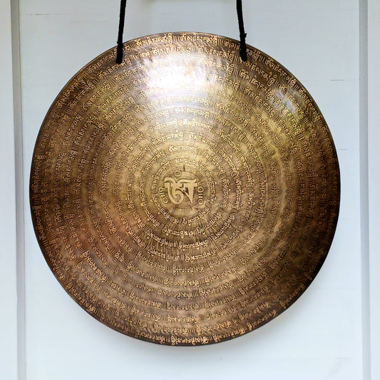 This stunning hand beaten Tibetan Gong is hand-etched with the Tibetan Buddhist Mantra Om mani padme hum and includes a large Om symbol in the centre.