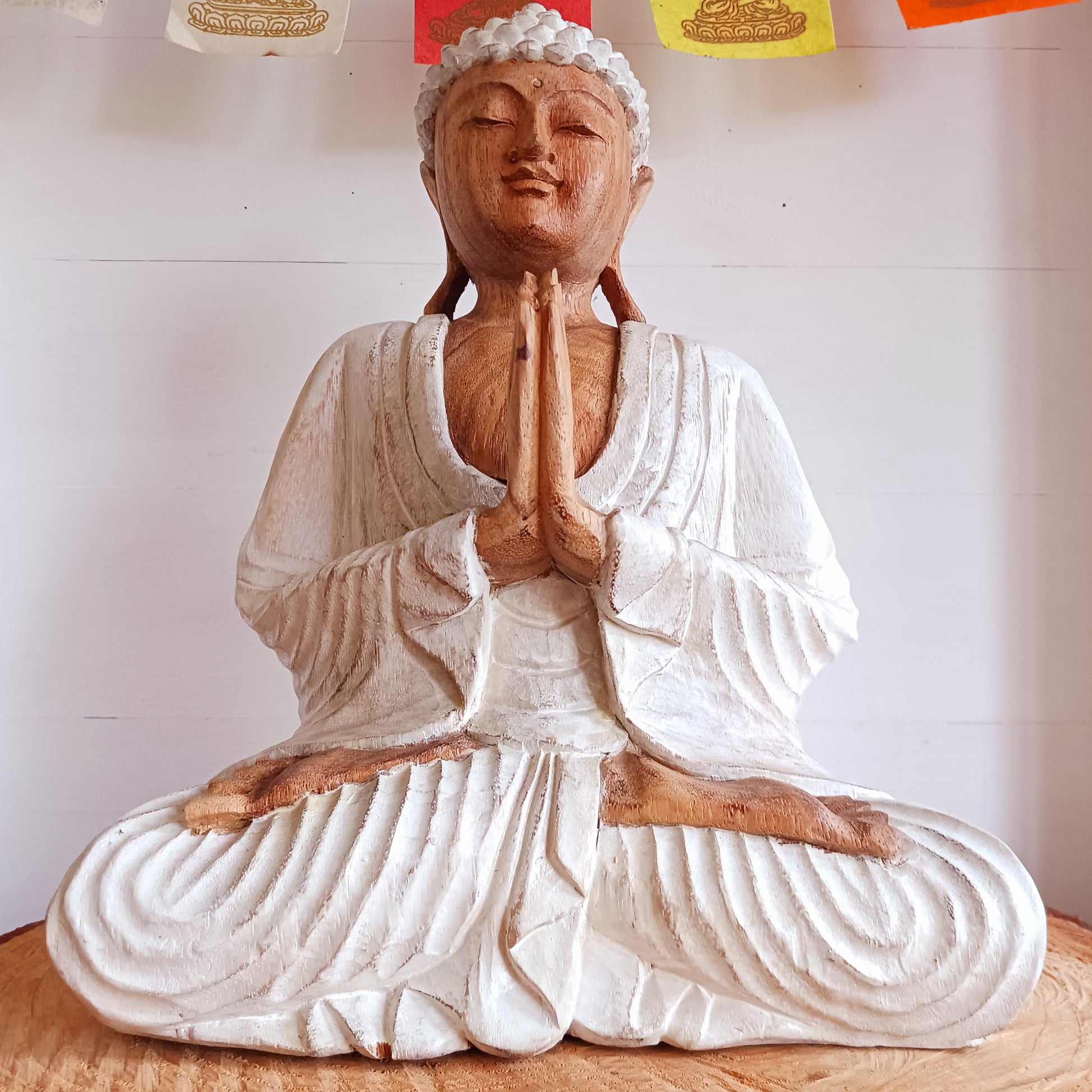 This Buddha statue has been carved by hand from Suar wood which is a fast-growing species, allowing for sustainable cultivation. The Albizia Saman species of tree is widespread, abundant, and in no danger of extinction. The Buddha is carved using tools in the traditional Balinese way, bringing each detail to life in a three-dimensional work of art. Hand carved Buddha statues can take up to weeks to carve and this particular Buddha has a white-wash finish.