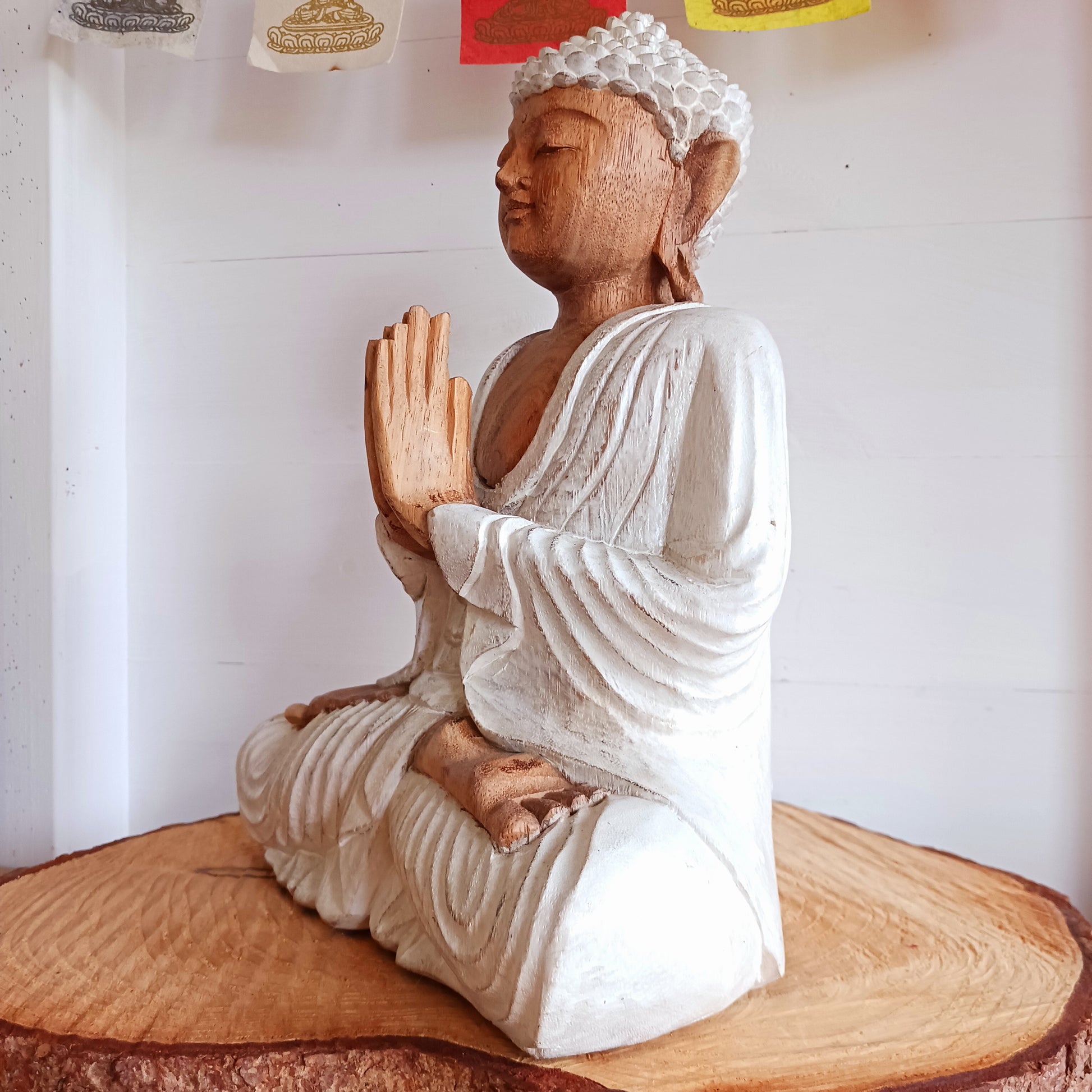 This Buddha statue has been carved by hand from Suar wood which is a fast-growing species, allowing for sustainable cultivation. The Albizia Saman species of tree is widespread, abundant, and in no danger of extinction. The Buddha is carved using tools in the traditional Balinese way, bringing each detail to life in a three-dimensional work of art. Hand carved Buddha statues can take up to weeks to carve and this particular Buddha has a white-wash finish.