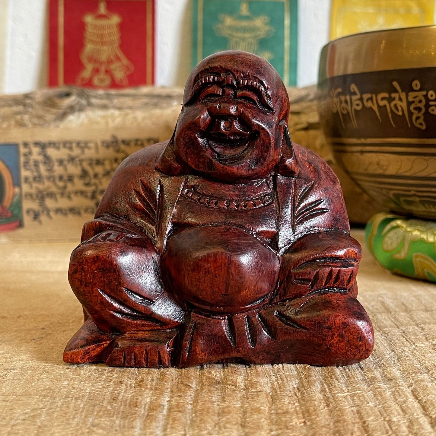 The Budai figure appears throughout Chinese culture as a representation of contentment and abundance, it is said that rubbing his protruding belly will bring the bearer wealth good luck and prosperity.   Solid laughing Buddha wood carving Beautifully hand carved in Raintree wood Hotei auspicious wooden statue