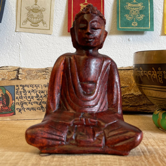 A stunning, hand carved wooden figure of Buddha, the founder of Buddhism. Our Buddhas have been hand carved in Bali using traditional methods of the island. Each carver has taken years perfecting his or her skill to be able to create work to this standard.  Hand carved wooden sitting Buddha  Made from Raintree wood in Bali