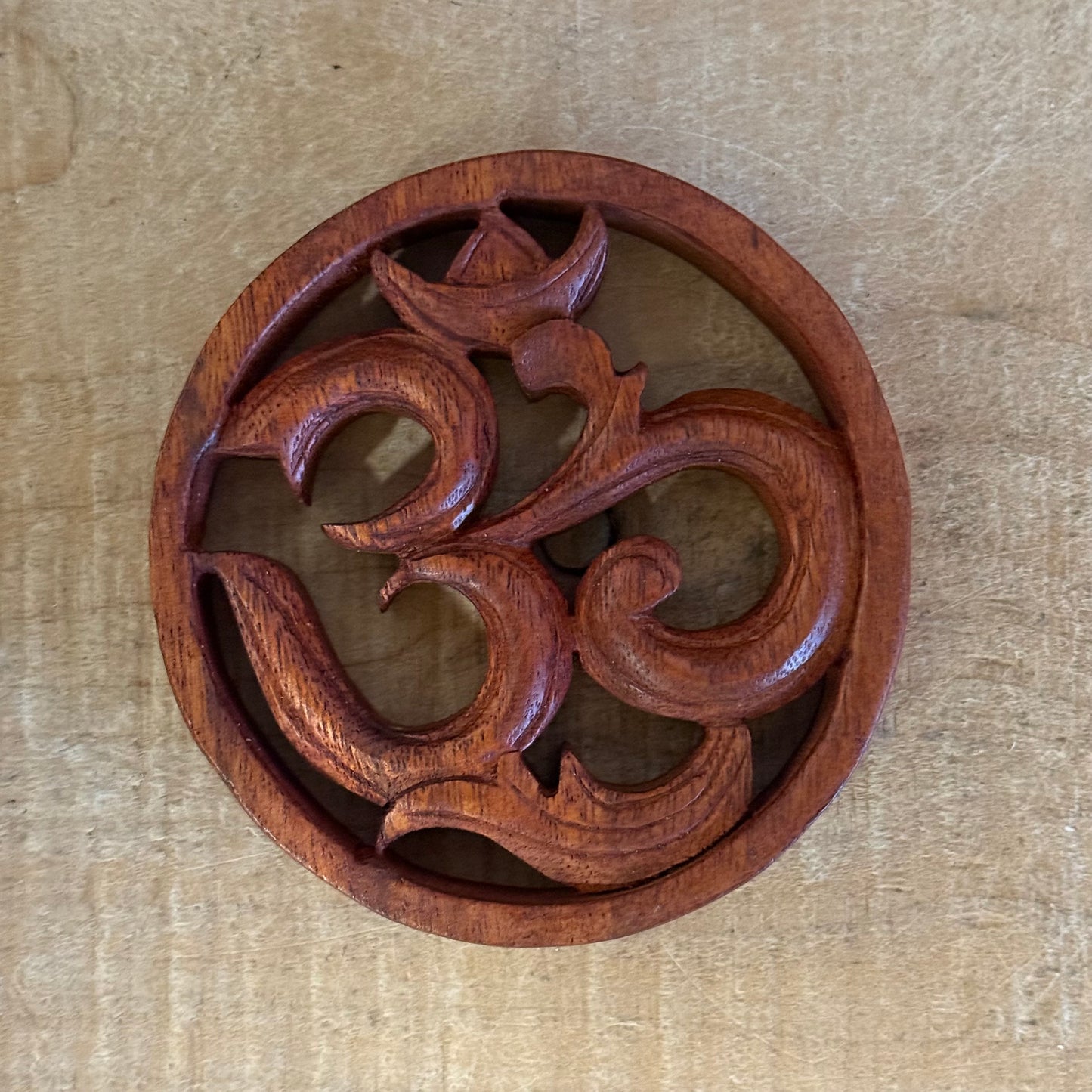 Bring harmony to your space with a Hand Carved Wooden Om Wall Hanging. Made from suar wood, symbol of peace and spiritual awakening.