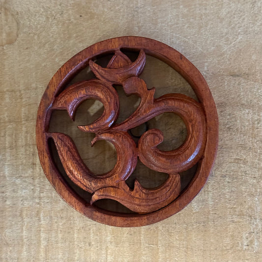 Bring harmony to your space with a Hand Carved Wooden Om Wall Hanging. Made from suar wood, symbol of peace and spiritual awakening.