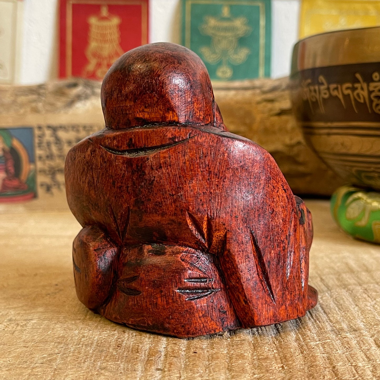 The Budai figure appears throughout Chinese culture as a representation of contentment and abundance, it is said that rubbing his protruding belly will bring the bearer wealth good luck and prosperity.   Solid laughing Buddha wood carving Beautifully hand carved in Raintree wood Hotei auspicious wooden statue