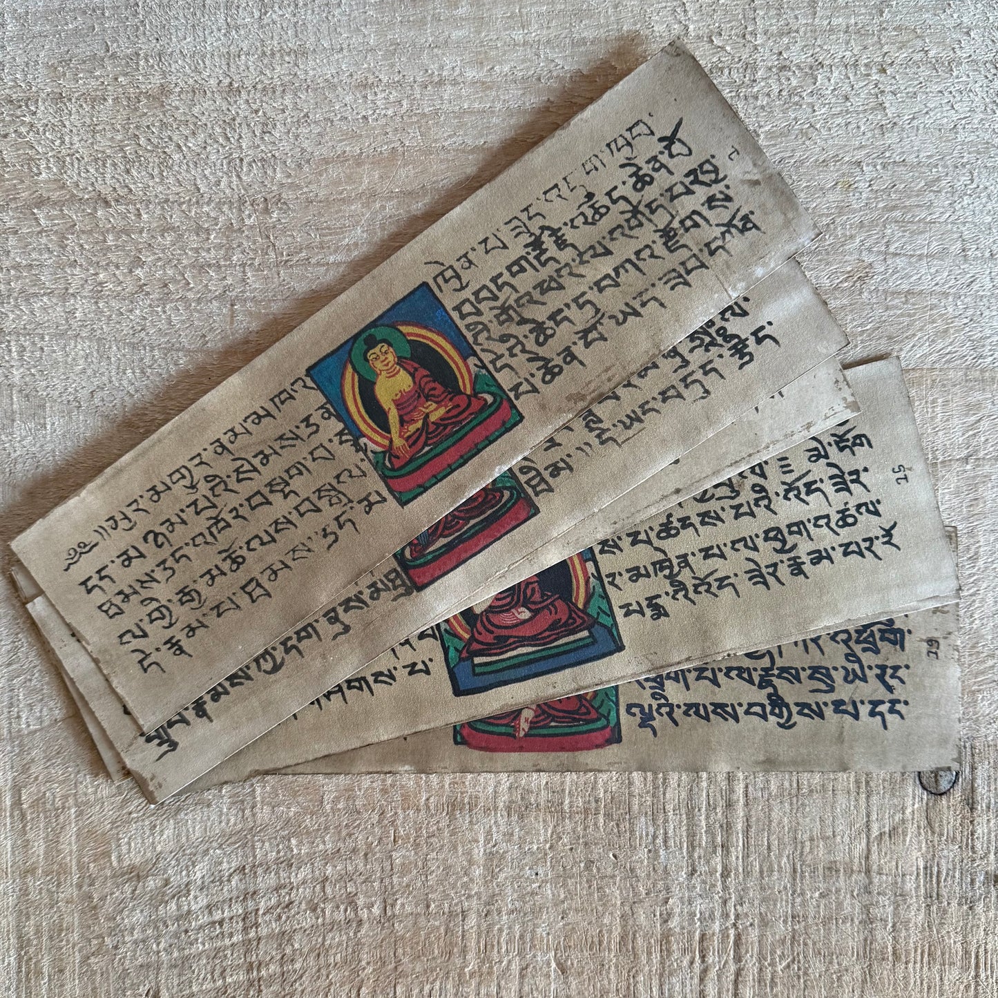 Handmade Tibetan Tantric Prayer Book with hand-painted Buddha and deities. Traditional Tibetan prayers on Daphne bark paper for health, prosperity, and meditation.