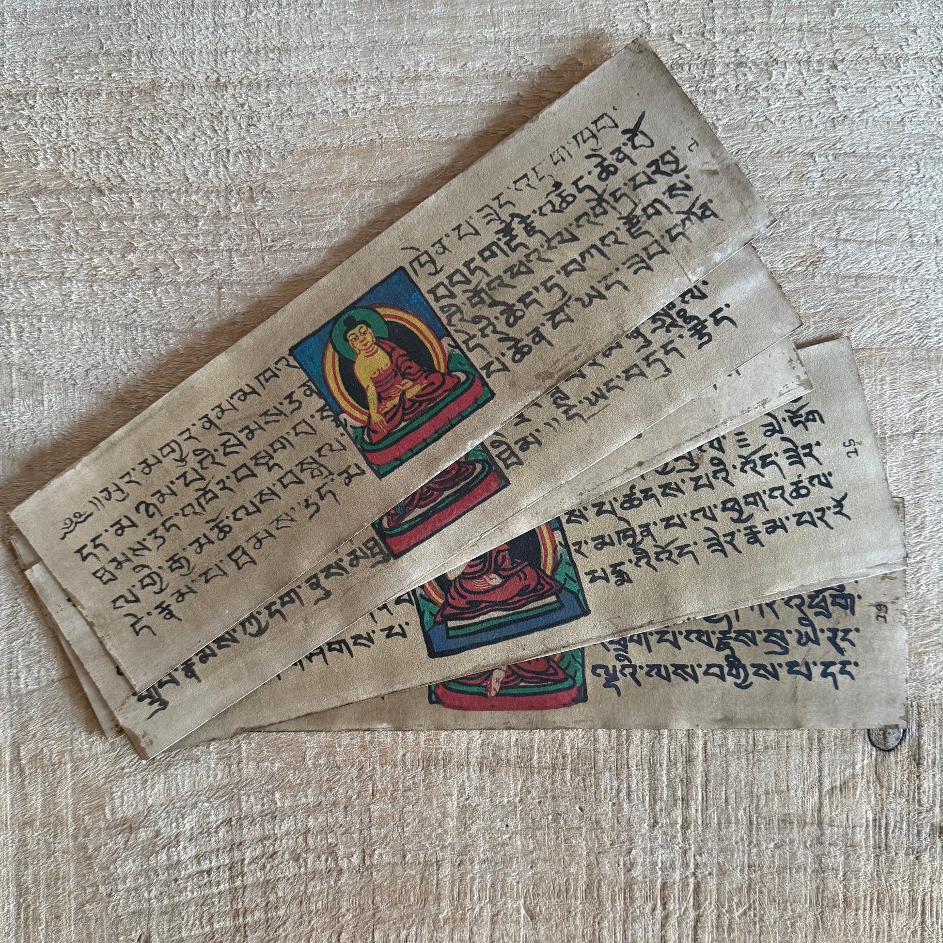 Handmade Tibetan Tantric Prayer Book with hand-painted Buddha and deities. Traditional Tibetan prayers on Daphne bark paper for health, prosperity, and meditation.