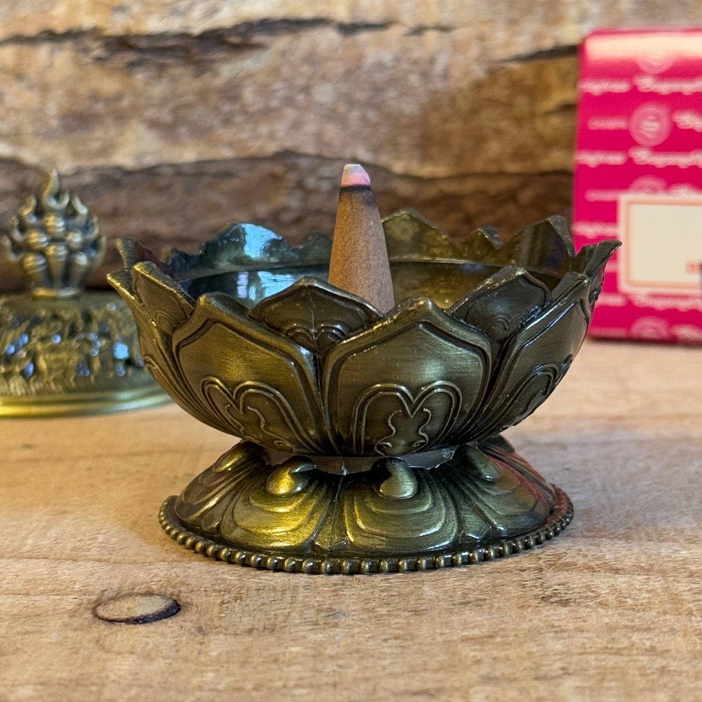 Enhance your home’s ambiance with this beautiful brass cone holder, thoughtfully designed in the shape of a lotus flower. Whether used for burning incense cones or as a charming decorative piece, this holder is both functional and elegant.

Key Features:
Elegant Lotus Design: The intricate lotus flower shape symbolizes purity and serenity, making it a meaningful addition to any space.
Majestic Smoke Display: Watch as the smoke gracefully curls through the lid’s opening, creating a soothing and captivating e