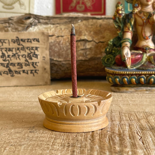 This is our most popular incense holder made from a single piece of yellow wood from Nepal. Each holder has been hand carved into a lotus and has a reasonably wide base to catch ash. The lotus shape is recognized as an important symbol in Buddhism.