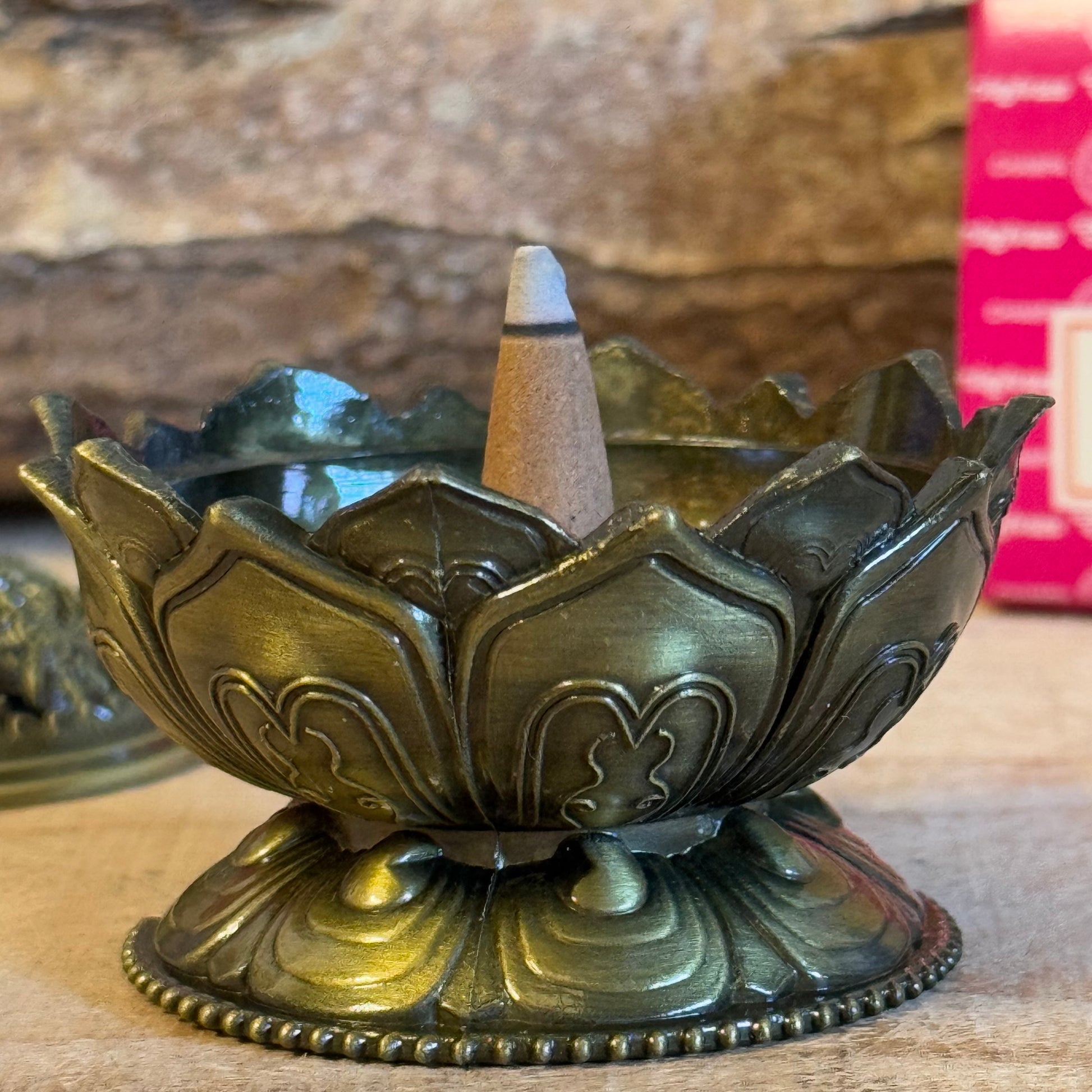 Enhance your home’s ambiance with this beautiful brass cone holder, thoughtfully designed in the shape of a lotus flower. Whether used for burning incense cones or as a charming decorative piece, this holder is both functional and elegant.

Key Features:
Elegant Lotus Design: The intricate lotus flower shape symbolizes purity and serenity, making it a meaningful addition to any space.
Majestic Smoke Display: Watch as the smoke gracefully curls through the lid’s opening, creating a soothing and captivating e