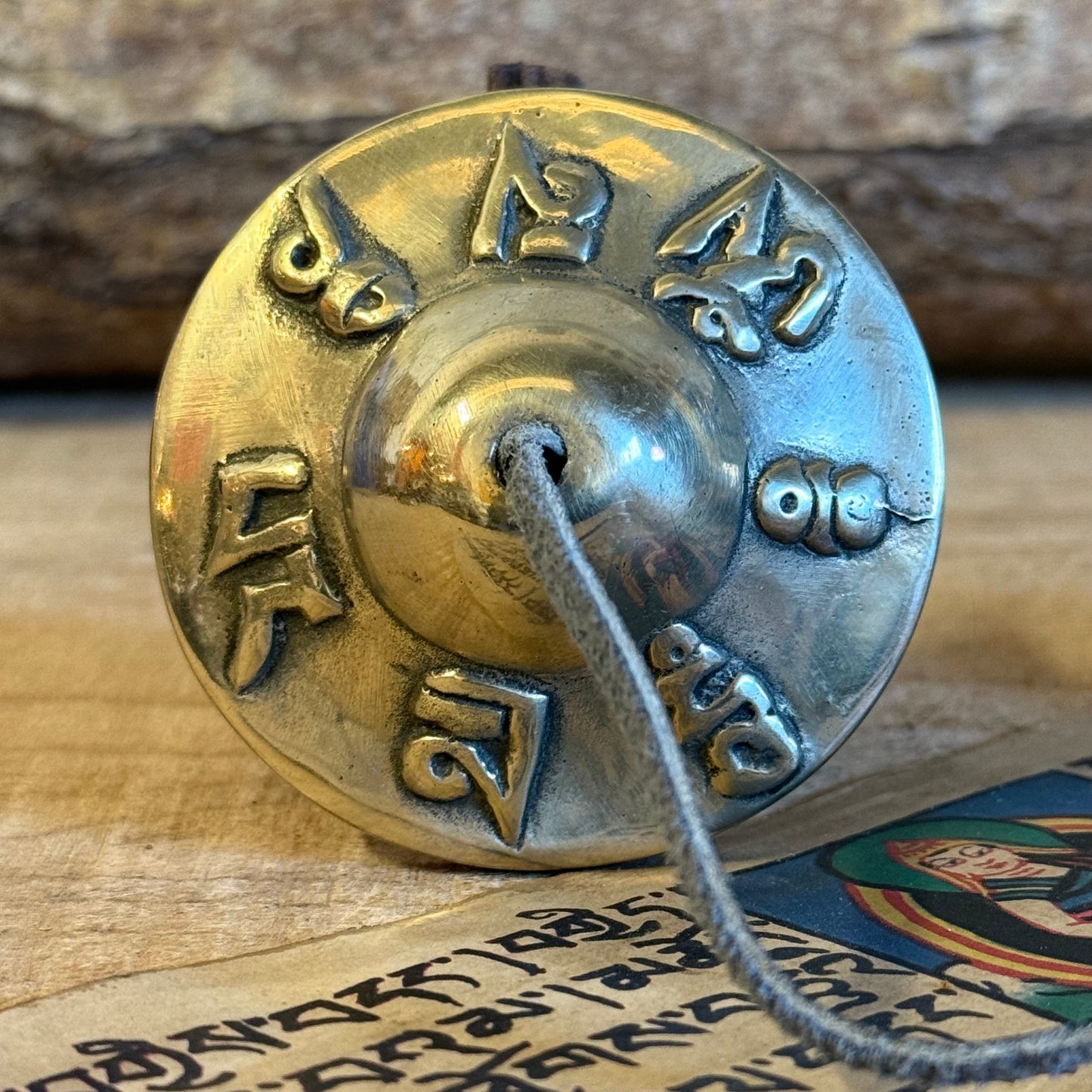 Tingsa or Tingsha are two small cymbals that are used by Buddhists during offerings, prayer and meditation. The cymbals are generally joined together by a leather strap and produce a clear, high pitched ringing tone when struck together.