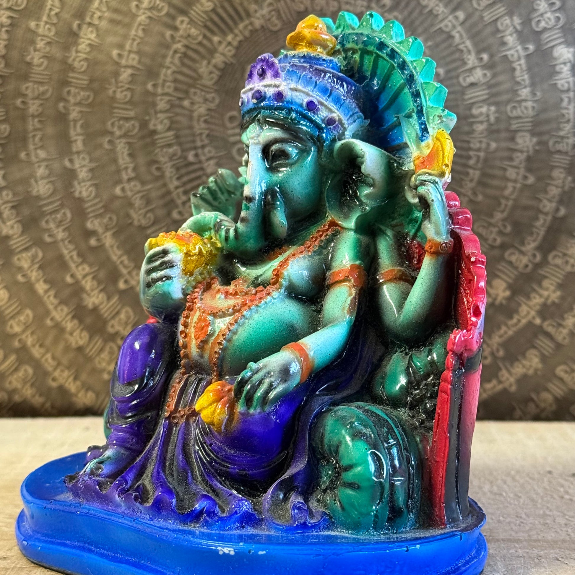 Hand-painted 15 cm resin Ganesh statue holding lotus, axe, and sweets.