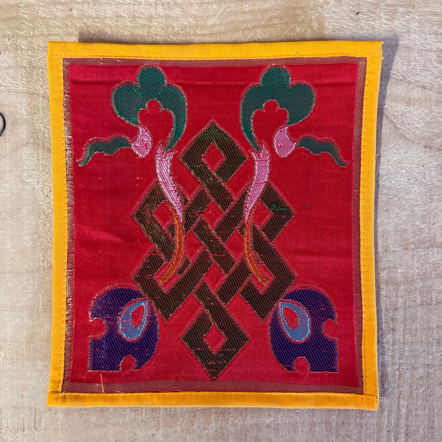 Handmade Tibetan mini altar cloth with Endless Knot and Dharma Wheel. Perfect for meditation, singing bowls, and sacred altar rituals. 17 x 17 cm silk brocade.
