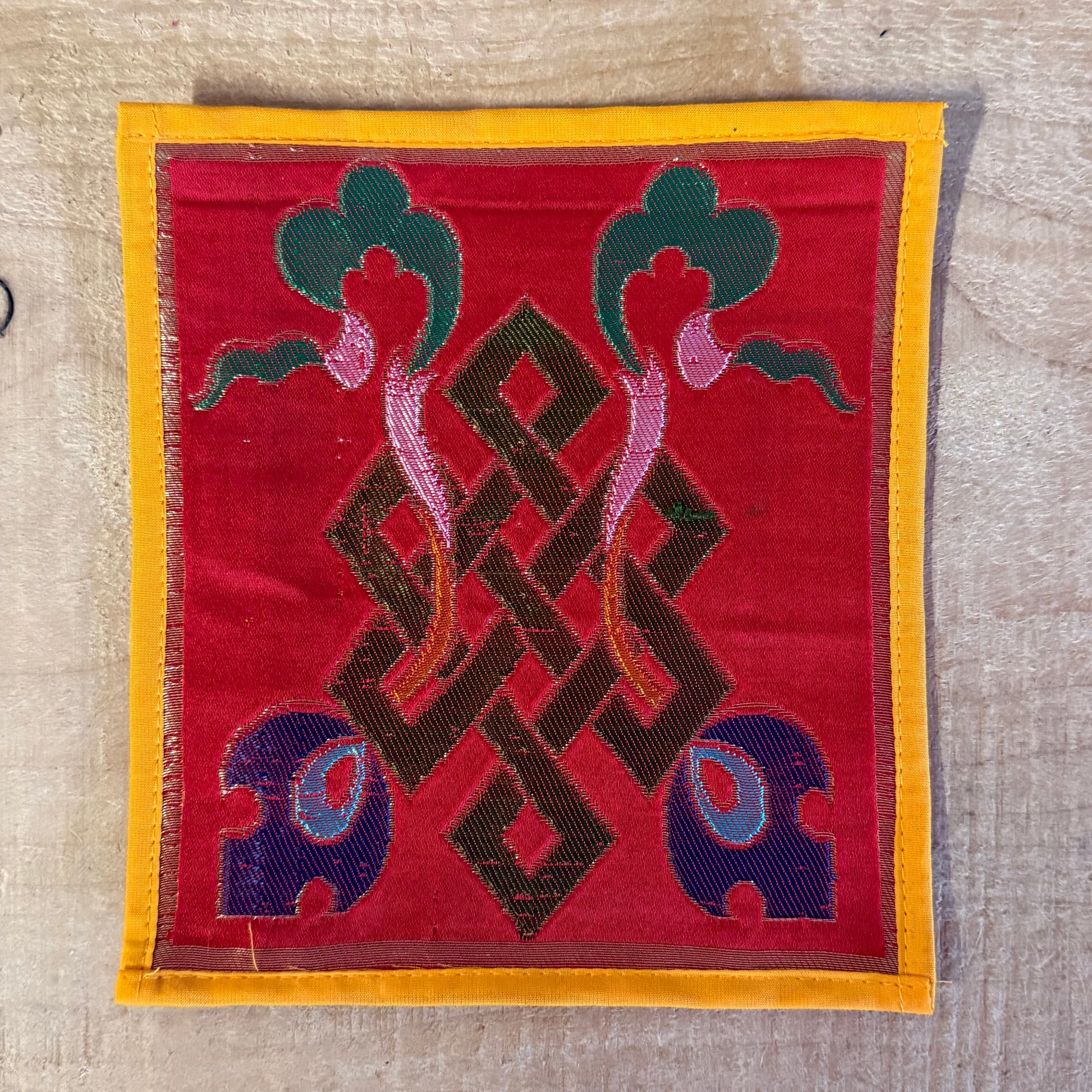 Handmade Tibetan mini altar cloth with Endless Knot and Dharma Wheel. Perfect for meditation, singing bowls, and sacred altar rituals. 17 x 17 cm silk brocade.