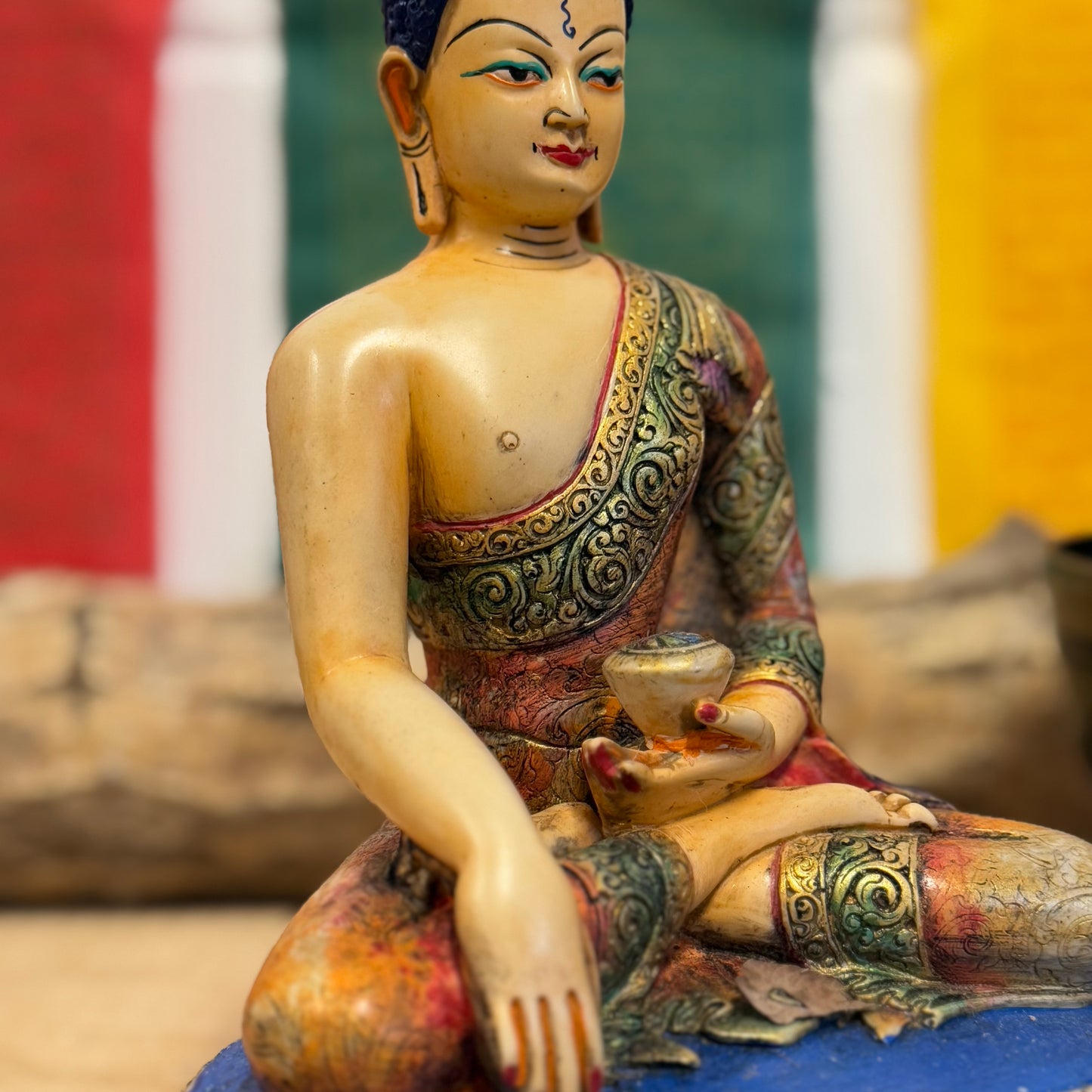 Hand-Painted Shakyamuni Buddha Statue – Traditional Thangka Style – 20cm

This stunning Shakyamuni Buddha statue, crafted from clay and resin, is a beautiful representation of supreme awareness and compassionate understanding. Painted using the traditional Thangka colors, this statue adheres to the exact color descriptions prescribed in Buddhist tradition, ensuring an authentic and vibrant depiction of the Buddha. Each piece is hand-painted by skilled artisans in Nepal, reflecting the meticulous craftsmansh