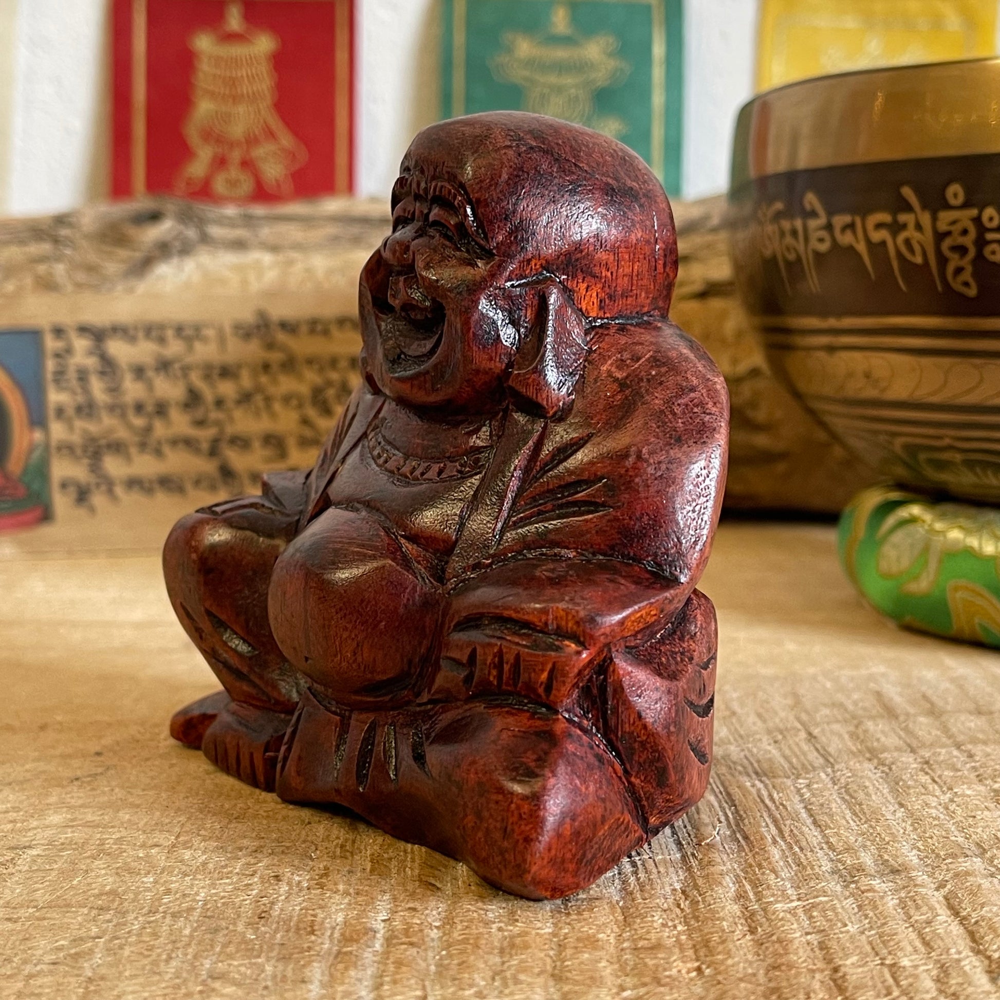 The Budai figure appears throughout Chinese culture as a representation of contentment and abundance, it is said that rubbing his protruding belly will bring the bearer wealth good luck and prosperity.   Solid laughing Buddha wood carving Beautifully hand carved in Raintree wood Hotei auspicious wooden statue