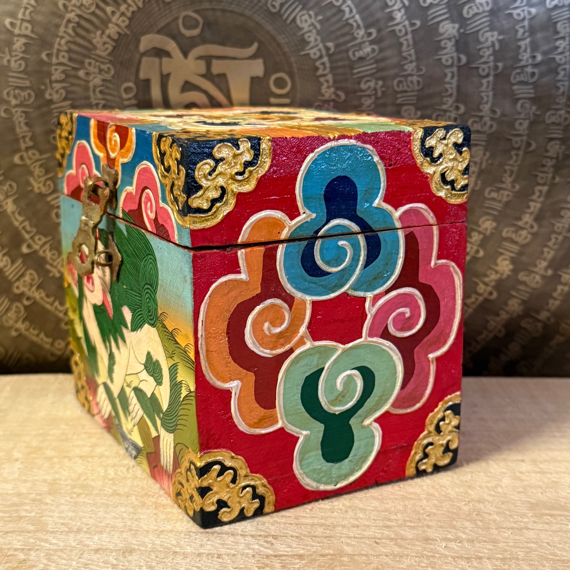 Hand-painted Tibetan square wooden box from Nepal, decorated with Buddhist symbols. Fairtrade, unique storage for jewellery or altar items.