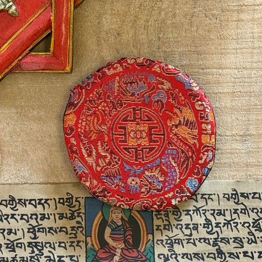 Small Round Singing Bowl Cushion | Buddhist singing Bowl Accessories

Enhance your practice with our brocade singing bowl cushion. Handmade in Nepal, it stabilizes your bowl for pure sound and adds beauty to your sacred space.