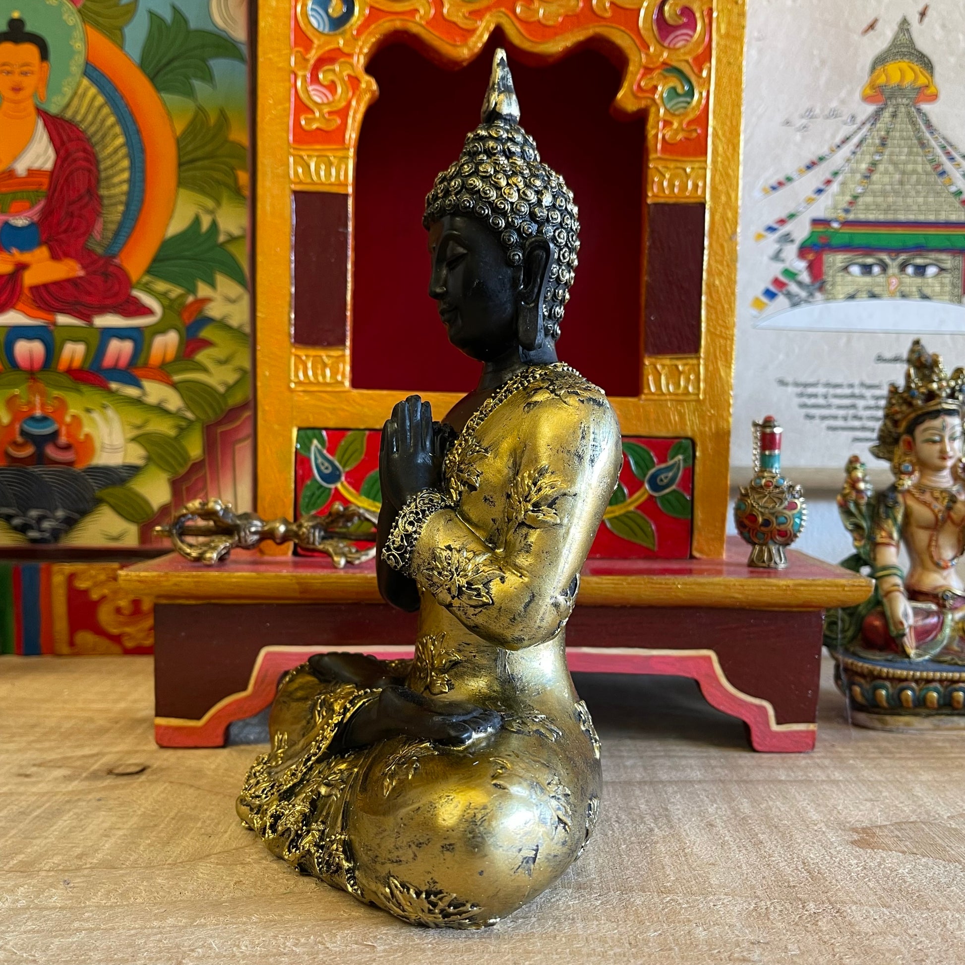 Thai style Buddha with vintage look and praying mudra (hand gesture).  The Anjali mudra is done by placing both hands close to the chest with the palms and fingers joined against each other vertically. It is believed that the enlightened Buddhas do not make this hand gesture because it is mainly for the Bodhisattvas who aim or are preparing to attain enlightenment or perfect knowledge.  Feng Shui Tip: Your main entrance, dining or living room is the right spot to place the Buddha with this mudra.