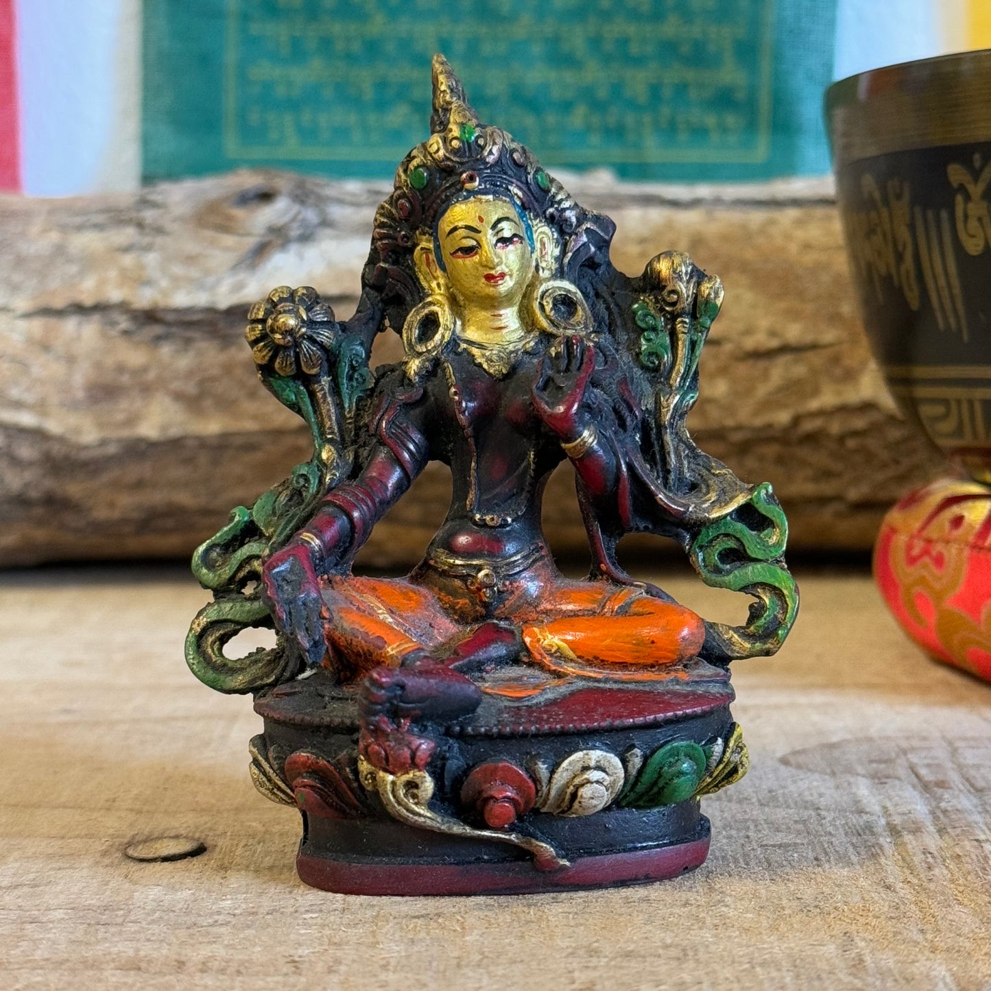 "Hand-painted 10 cm Green Tara resin statue with intricate details. Depicts compassion and readiness with protective and giving mudras. Perfect for altars or gifting!"