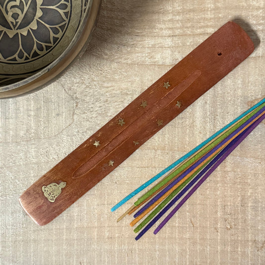 Handcrafted wooden incense holder with brass Buddha inlay for clean, mindful burning and peaceful ritual spaces.