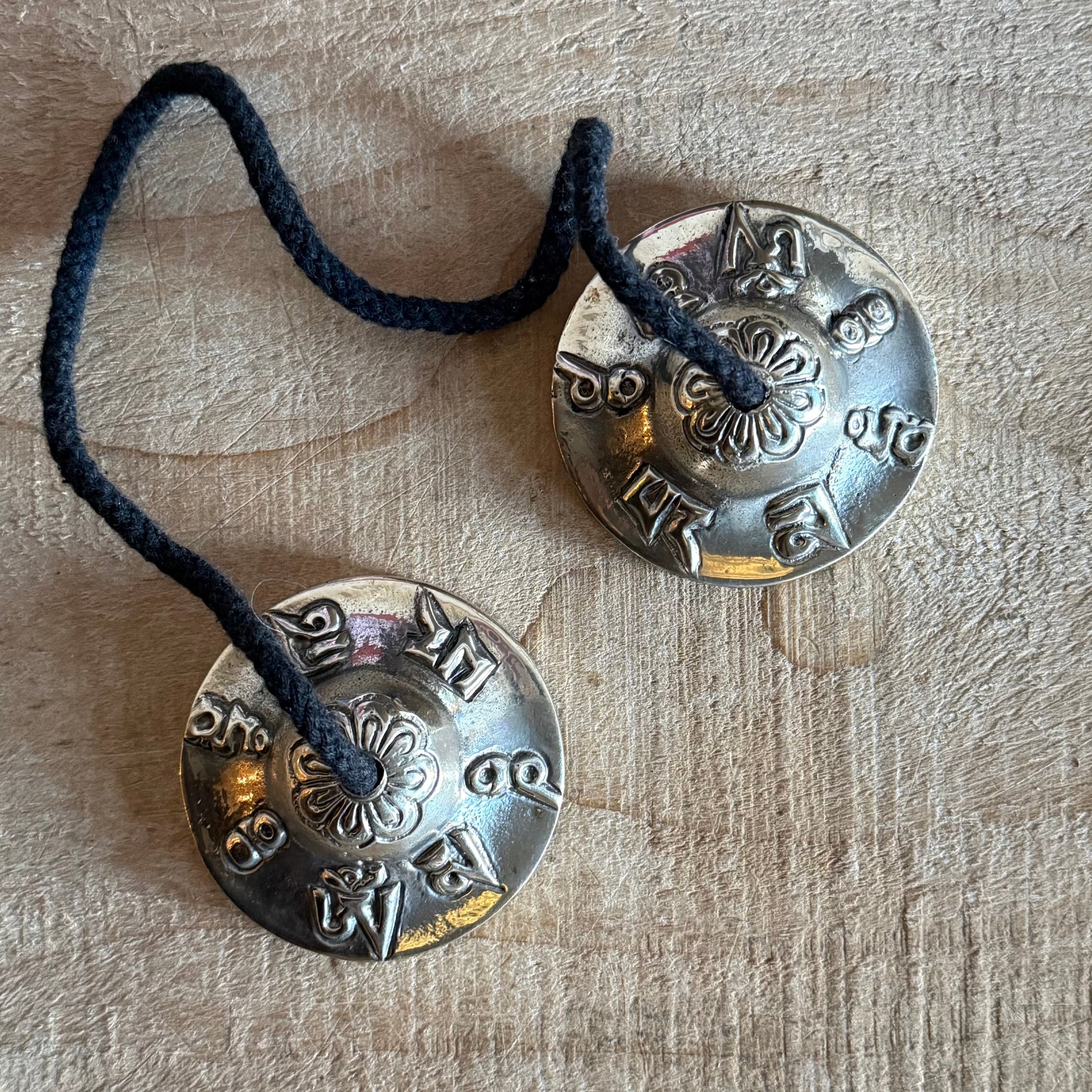Vegan Tibetan tingsha cymbals with cotton strap. Ideal for meditation, prayer, sound healing, and space clearing. Handmade in Nepal.