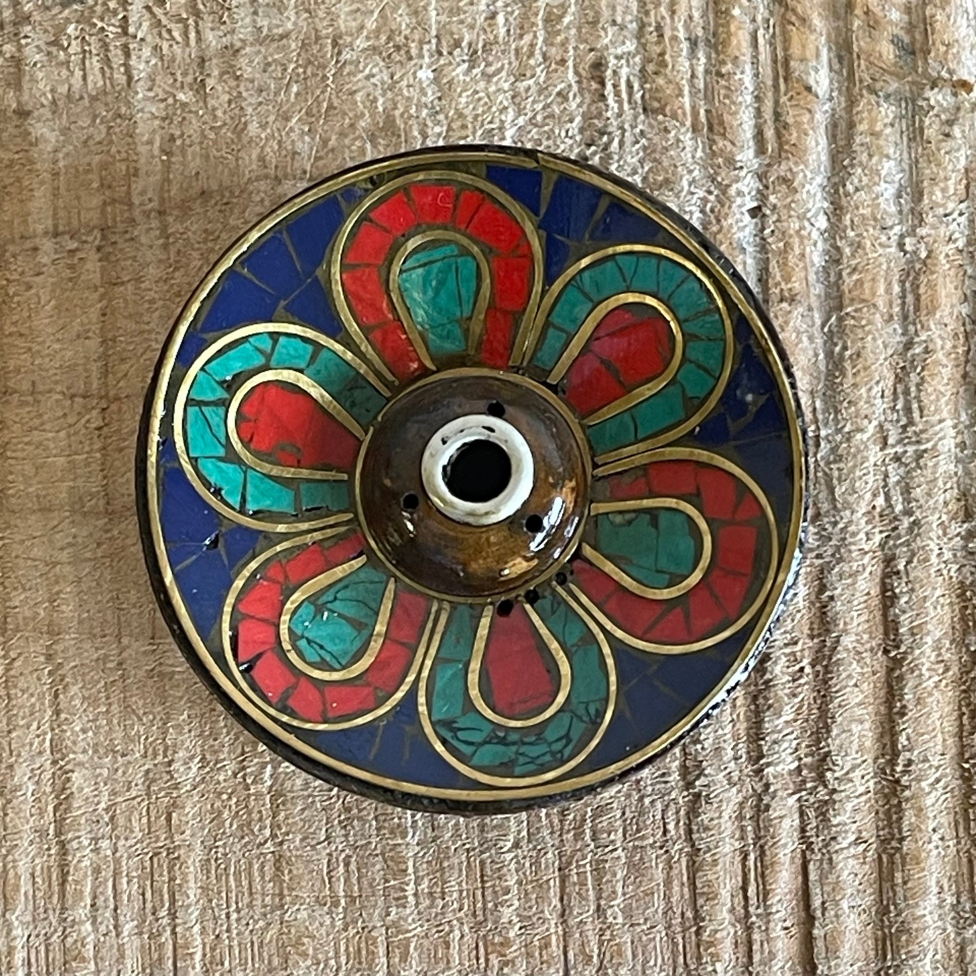 A beautiful Hand painted Tibetan Incense stick holder , Hand painted and ethically sourced this incense Holder is Perfect for the Larger Tibetan Incense it also has 4 small holes for Indian sticks.