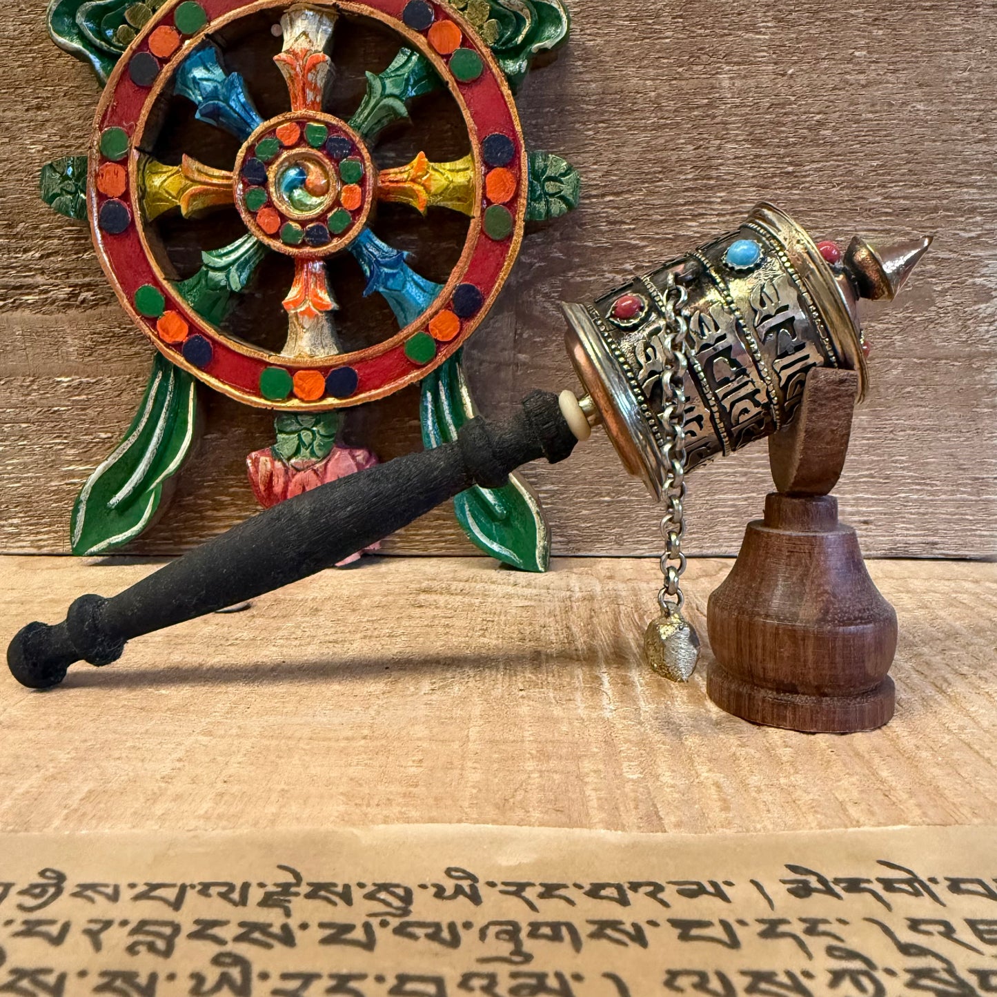 This sacred handheld prayer wheel carries the timeless mantra Om Mani Padme Hum, not just on its surface—but within its very core.

Measuring approximately 23cm in length, this traditional Buddhist Mani Wheel is crafted from metal and fitted with a smooth wooden handle. Inside the wheel, a sacred scroll contains thousands of repetitions of the mantra, empowering each rotation with the spiritual energy of compassion and wisdom.