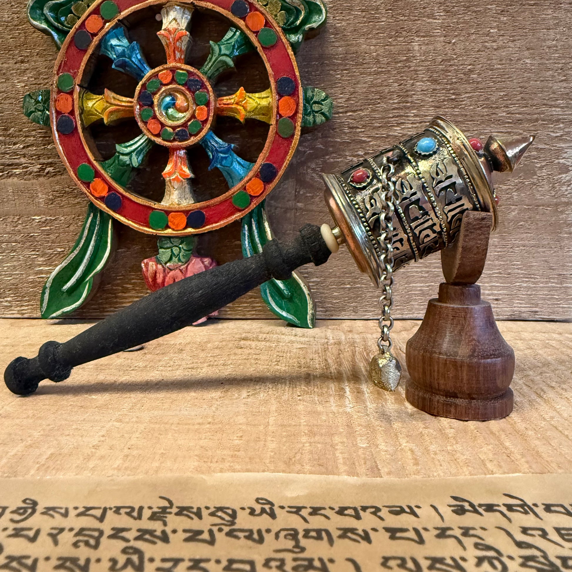 This sacred handheld prayer wheel carries the timeless mantra Om Mani Padme Hum, not just on its surface—but within its very core.

Measuring approximately 23cm in length, this traditional Buddhist Mani Wheel is crafted from metal and fitted with a smooth wooden handle. Inside the wheel, a sacred scroll contains thousands of repetitions of the mantra, empowering each rotation with the spiritual energy of compassion and wisdom.
