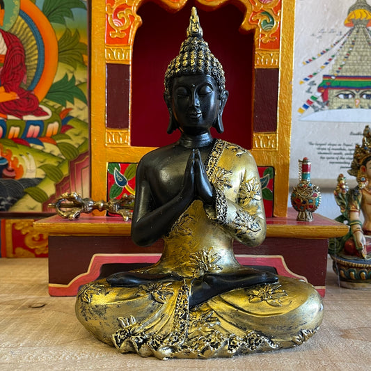 Thai style Buddha with vintage look and praying mudra (hand gesture).  The Anjali mudra is done by placing both hands close to the chest with the palms and fingers joined against each other vertically. It is believed that the enlightened Buddhas do not make this hand gesture because it is mainly for the Bodhisattvas who aim or are preparing to attain enlightenment or perfect knowledge.  Feng Shui Tip: Your main entrance, dining or living room is the right spot to place the Buddha with this mudra.