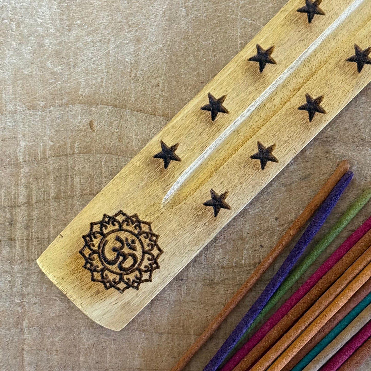 Hand carved mango wood incense ashcatcher with Om symbol. 26cm wooden incense holder for meditation, yoga, and spiritual altar spaces.
