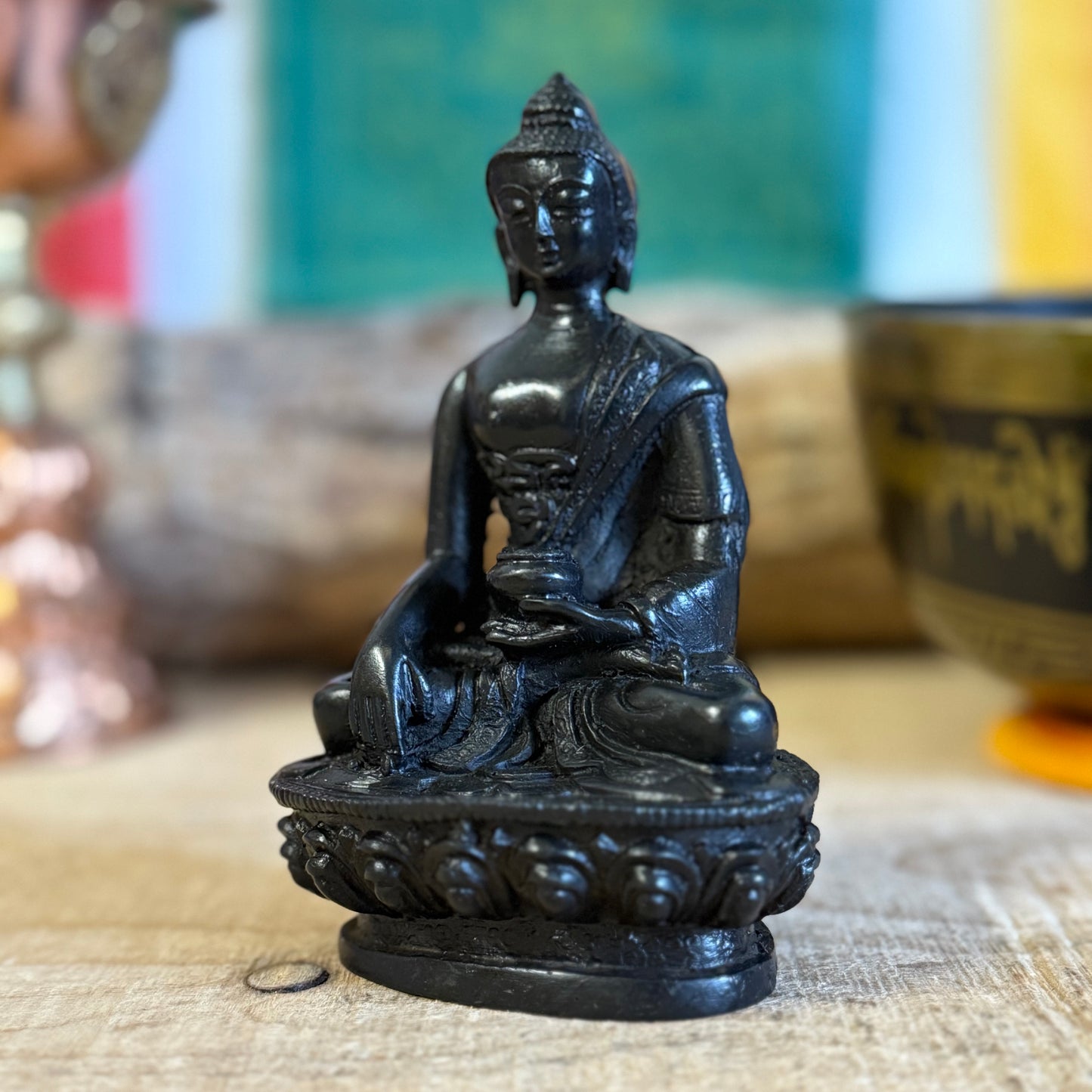 Shop this handcrafted Nepalese resin Buddha figurine featuring the Touching the Earth mudra,  symbolizing enlightenment and virtue. A perfect addition to your home or meditation space.