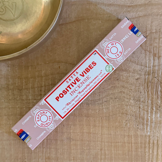 Satya Positive Vibes Incense blends sandalwood and floral oils into a warm, uplifting aroma, hand rolled in India for meditation and calm living