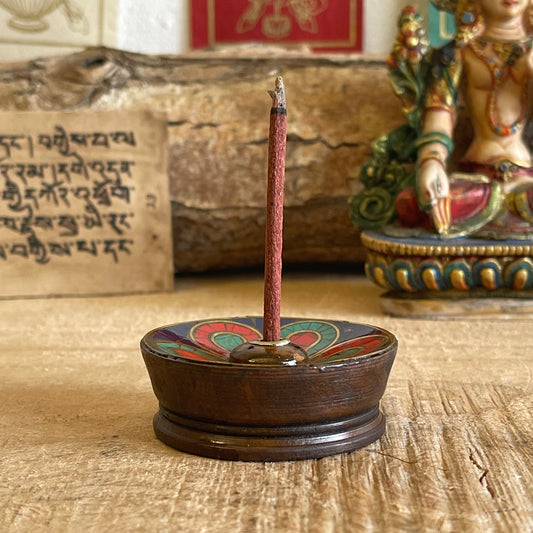 A beautiful Hand painted Tibetan Incense stick holder , Hand painted and ethically sourced this incense Holder is Perfect for the Larger Tibetan Incense it also has 4 small holes for Indian sticks.