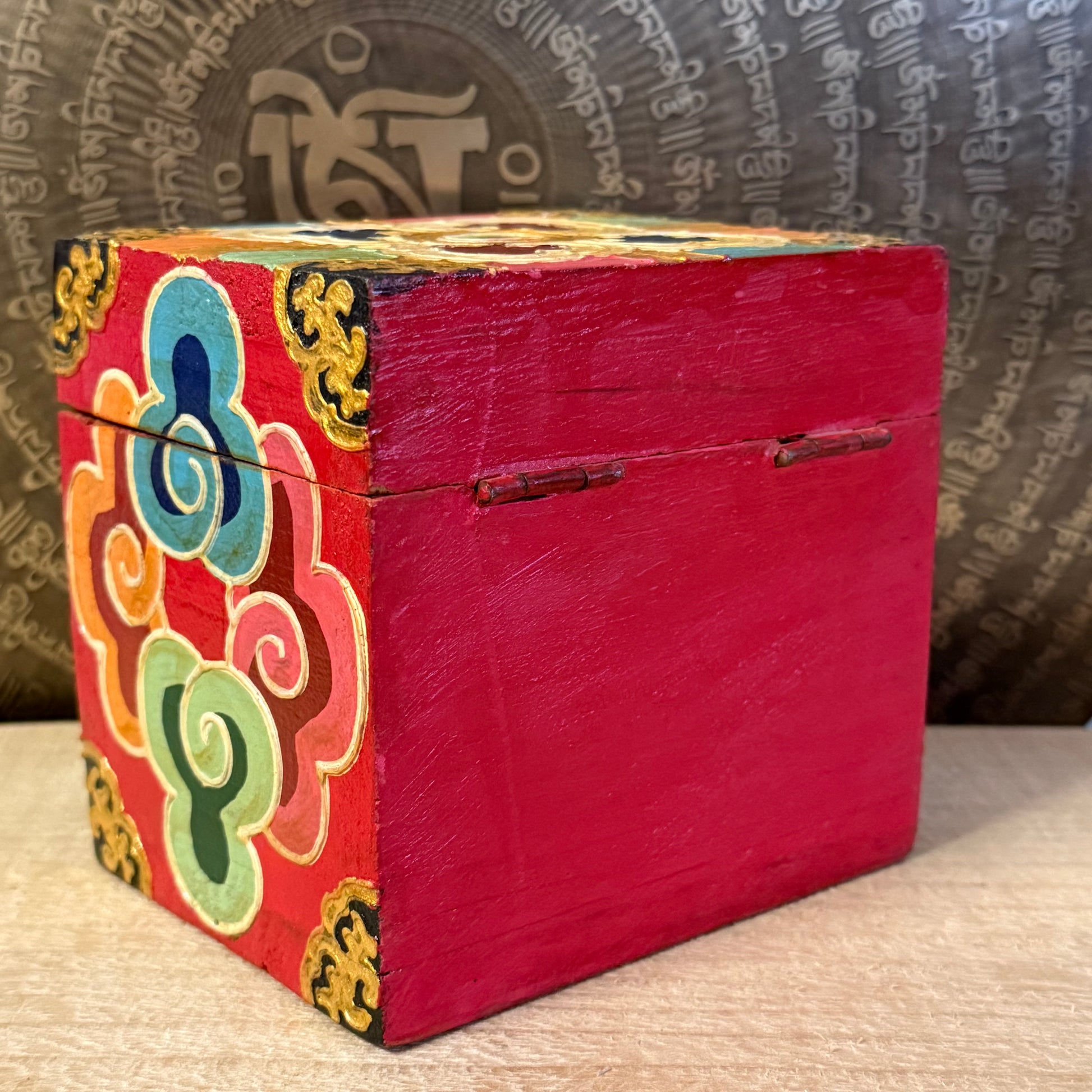 Hand-painted Tibetan square wooden box from Nepal, decorated with Buddhist symbols. Fairtrade, unique storage for jewellery or altar items.