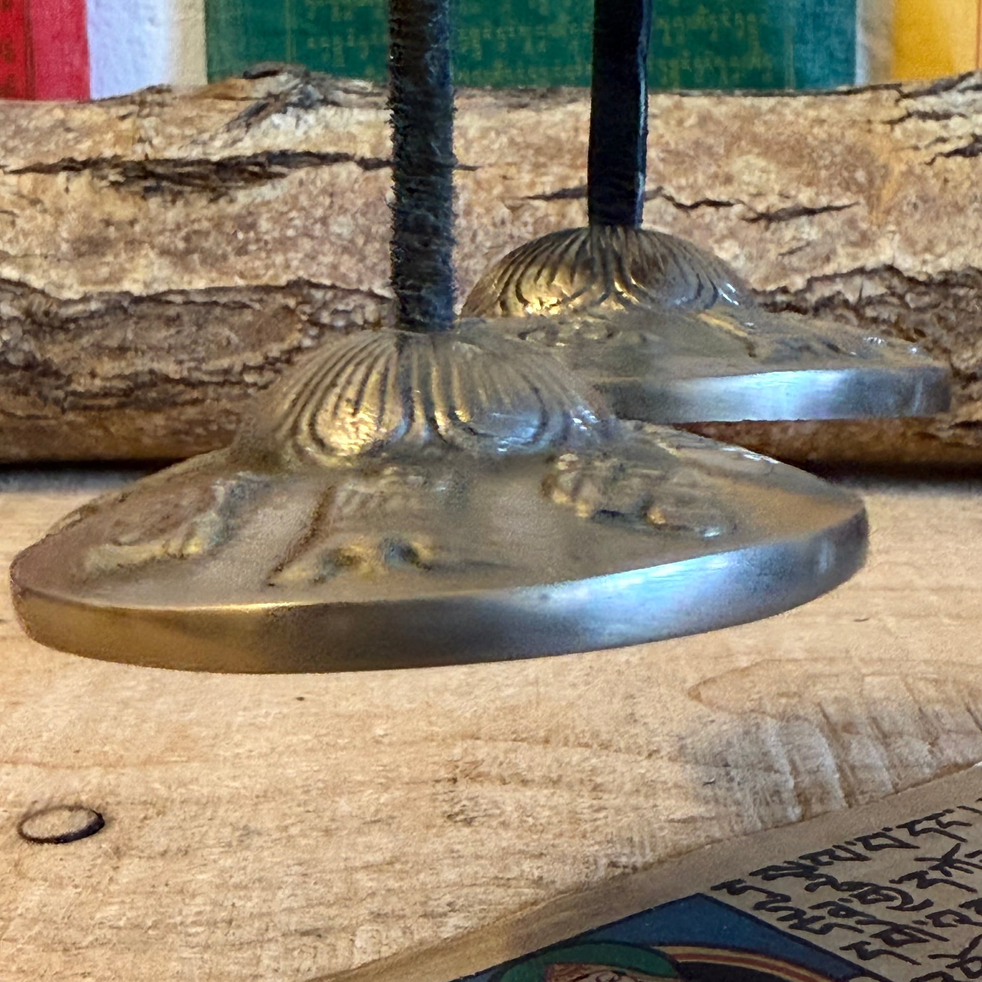 A&nbsp;Tingsha is a small pair of hand-cymbals traditionally used in Tibetan Buddhist practices. They consist of two small, round metal plates connected by a leather or fabric strap. When struck together, they produce a clear, high-pitched, and resonant tone.