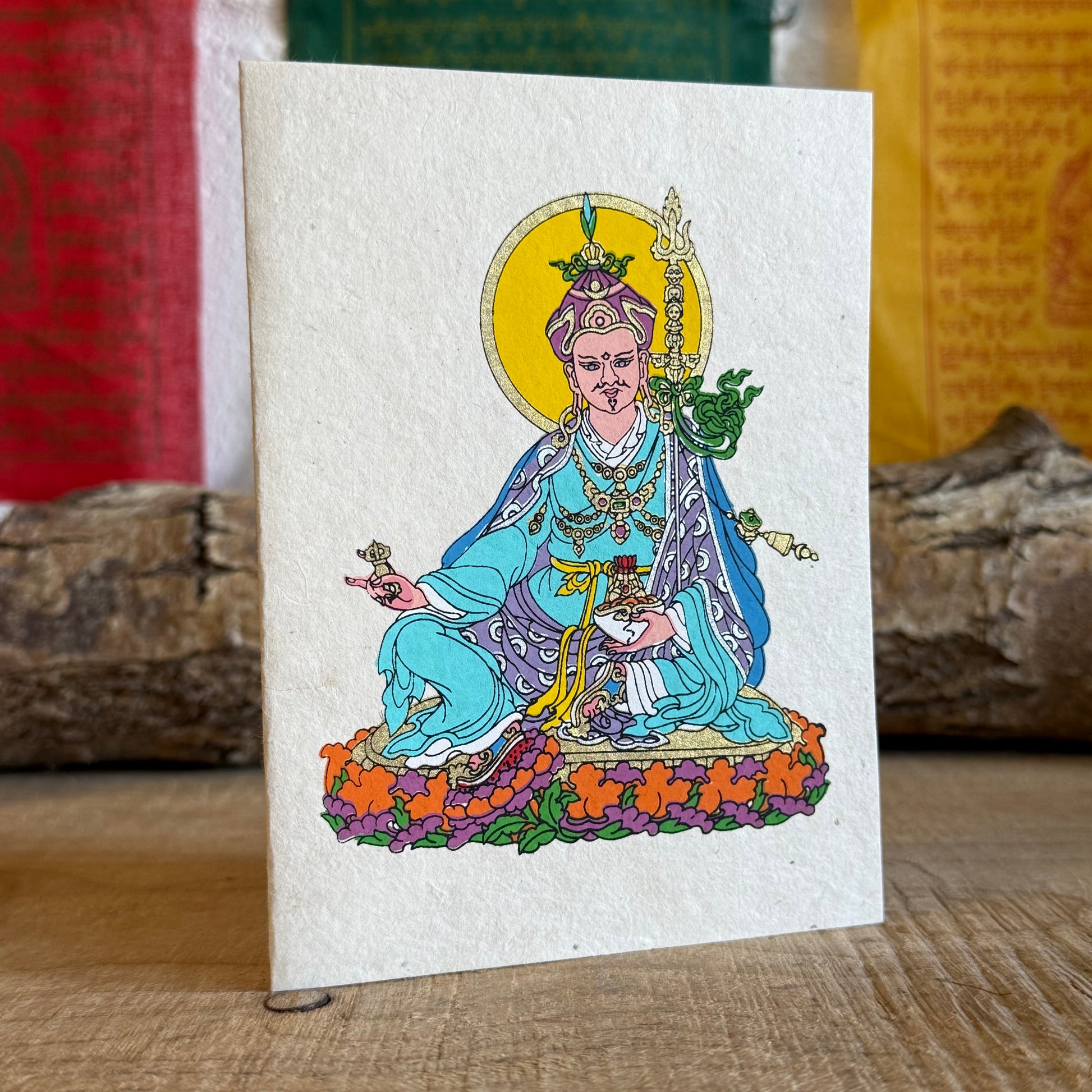 Beautifully coloured and decorated greetings card, made from Lokta paper, featuring Guru Padmasambhav.

Lokta paper making is a traditional practice from the high altitude Himalayan forests of Nepal. The Lokta bush is a fast growing shrub and the paper making process helps to provide economic stability for some of Nepal's poorer rural people.

Size: approx. 15.5 x 11.5 cm

☸Buddhist design Lokta paper card with envelopes
☸Made from a sustainable plant source
☸Handmade and Fairtrade from Nepal