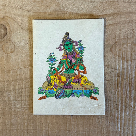 Invoke the swift compassion of Green Tara with this handcrafted Lokta Paper Greeting Card. Created by master artist Jimmy Thapa, each card is made using traditional Himalayan Lokta fibre, offering a sustainable and spiritually resonant finish. Blank inside with a matching envelope, it is ideal for blessings, celebrations, and meaningful correspondence. Natural colour and size variations reflect its handmade origin. Approx. 11 x 15 cm.