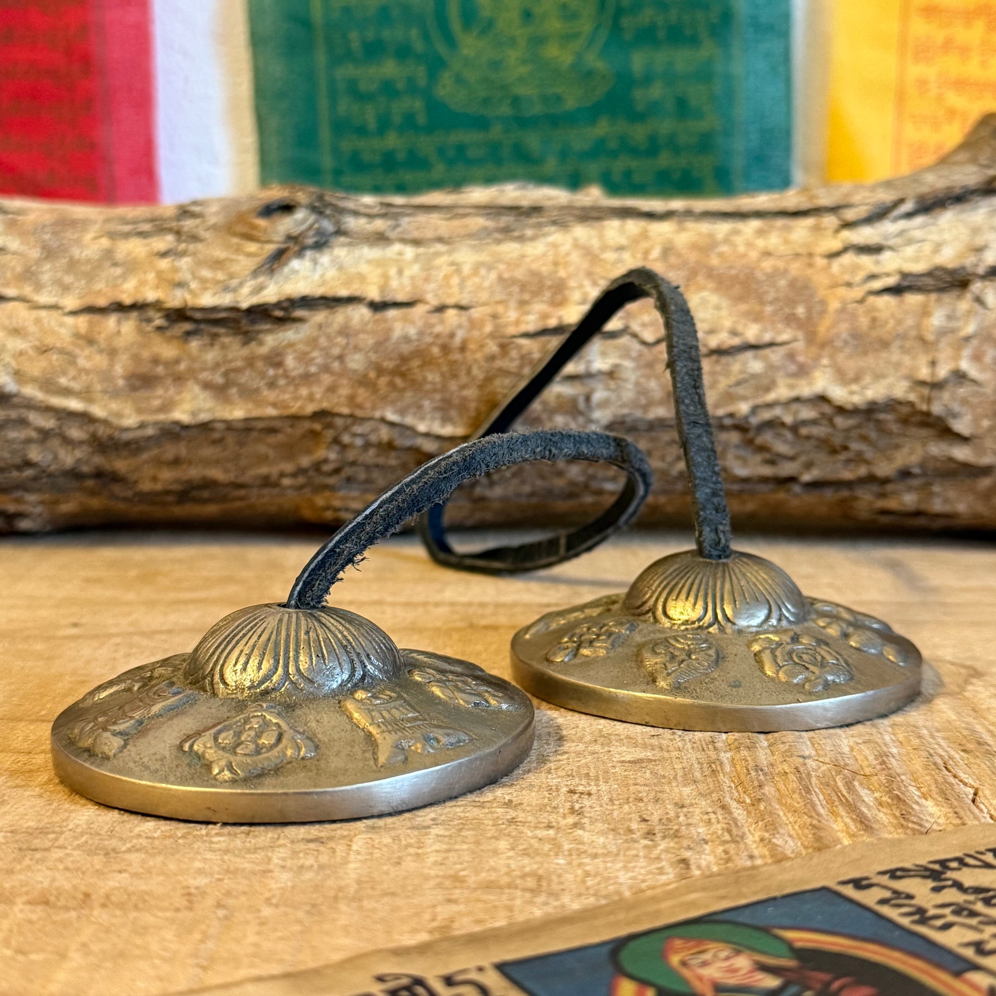 A&nbsp;Tingsha is a small pair of hand-cymbals traditionally used in Tibetan Buddhist practices. They consist of two small, round metal plates connected by a leather or fabric strap. When struck together, they produce a clear, high-pitched, and resonant tone.