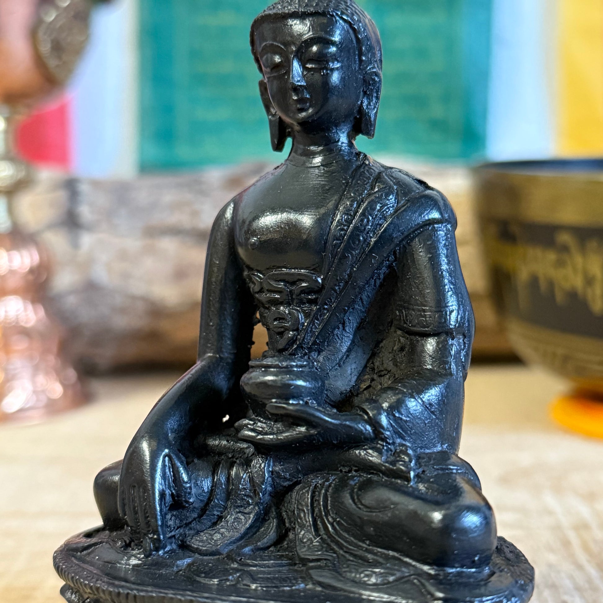 Shop this handcrafted Nepalese resin Buddha figurine featuring the Touching the Earth mudra,  symbolizing enlightenment and virtue. A perfect addition to your home or meditation space.