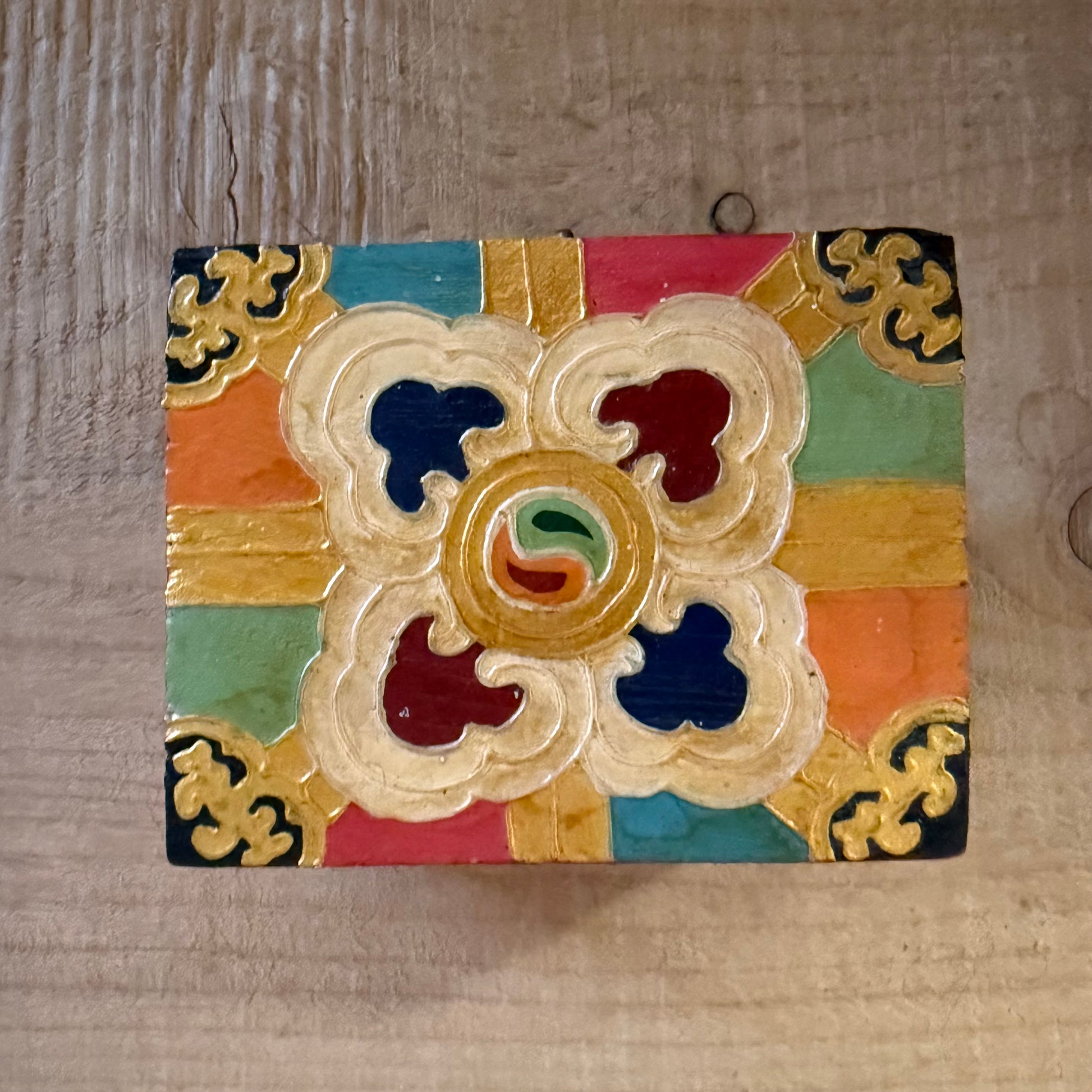 Hand-painted Tibetan square wooden box from Nepal, decorated with Buddhist symbols. Fairtrade, unique storage for jewellery or altar items.