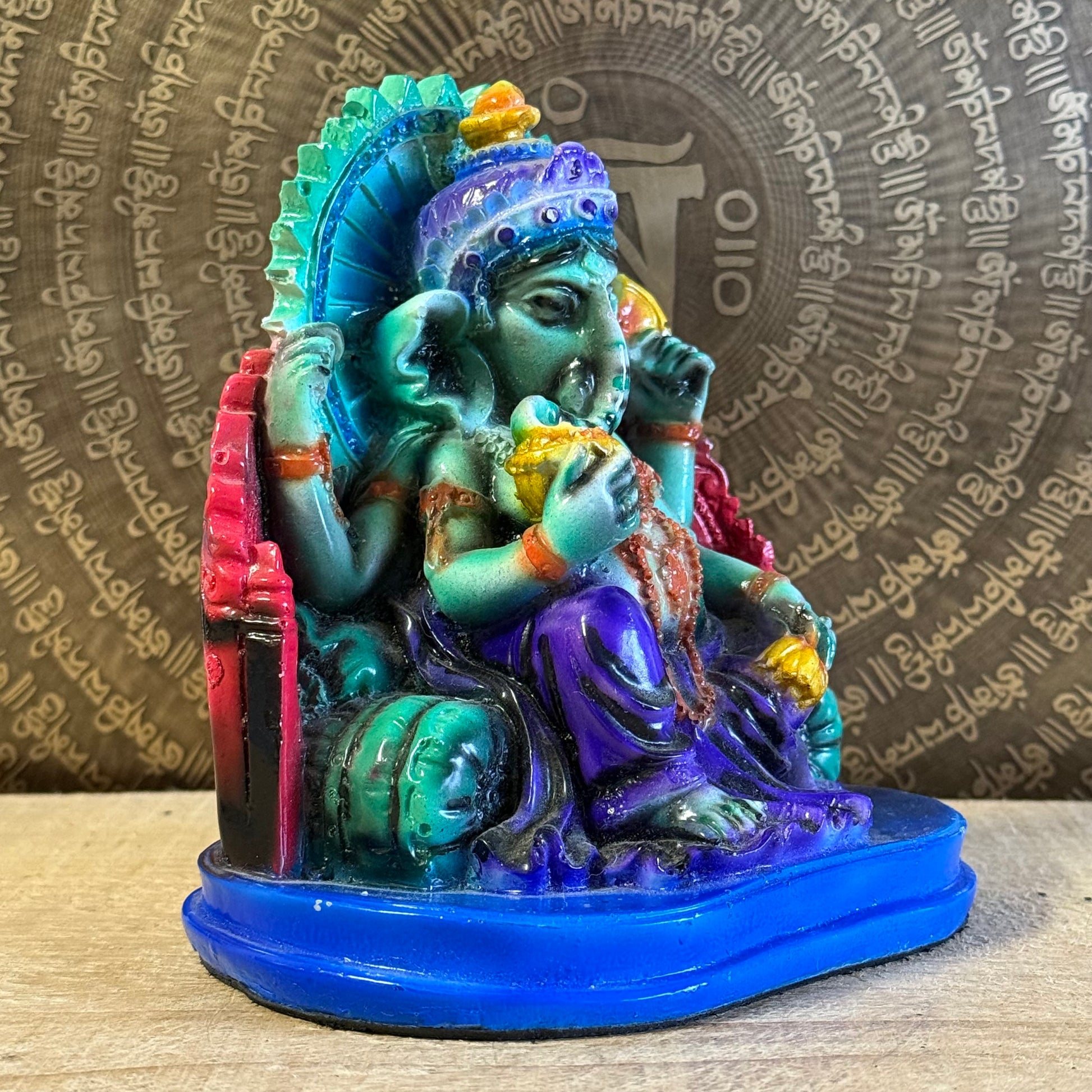 Hand-painted 15 cm resin Ganesh statue holding lotus, axe, and sweets.