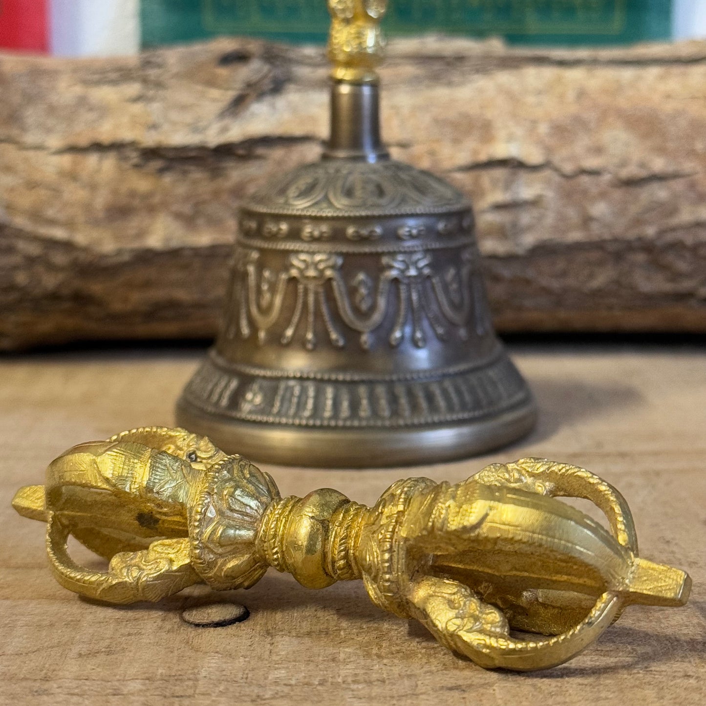 Discover the intricately engraved Kirtimukha Bell and Dorje Set, a primary ritual tool in Tibetan Buddhism. Handcrafted in Nepal, this bronze and brass set symbolizes wisdom and compassion, perfect for rituals and meditation.