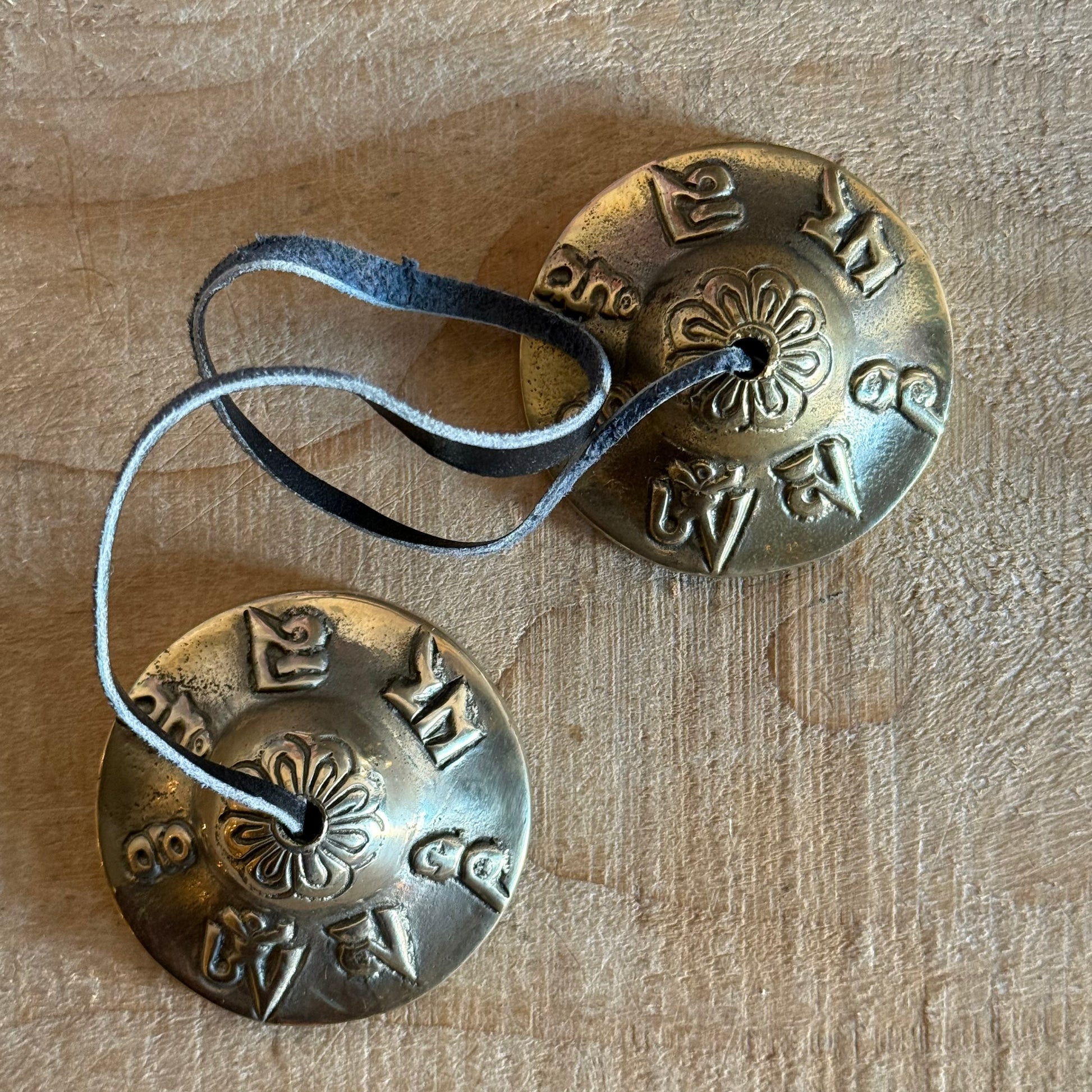 Om Mani Padme Hum Tingsha cymbals for meditation and rituals. Handmade in Nepal, engraved with sacred mantra, perfect for altars and spiritual practice.