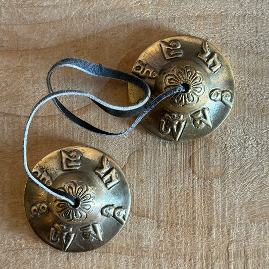 Om Mani Padme Hum Tingsha cymbals for meditation and rituals. Handmade in Nepal, engraved with sacred mantra, perfect for altars and spiritual practice.
