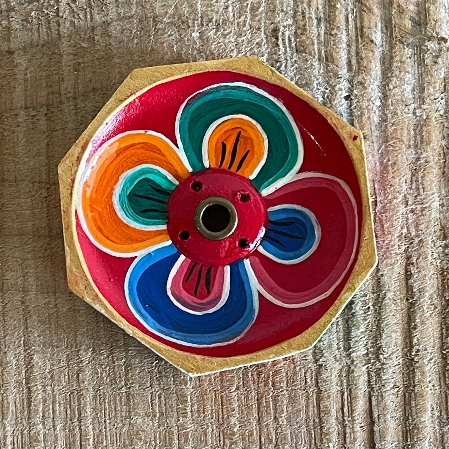 A beautiful Hand painted Tibetan Incense stick holder , Hand painted and ethically sourced this incense Holder is Perfect for the Larger Tibetan Incense it also has 4 small holes for Indian sticks.