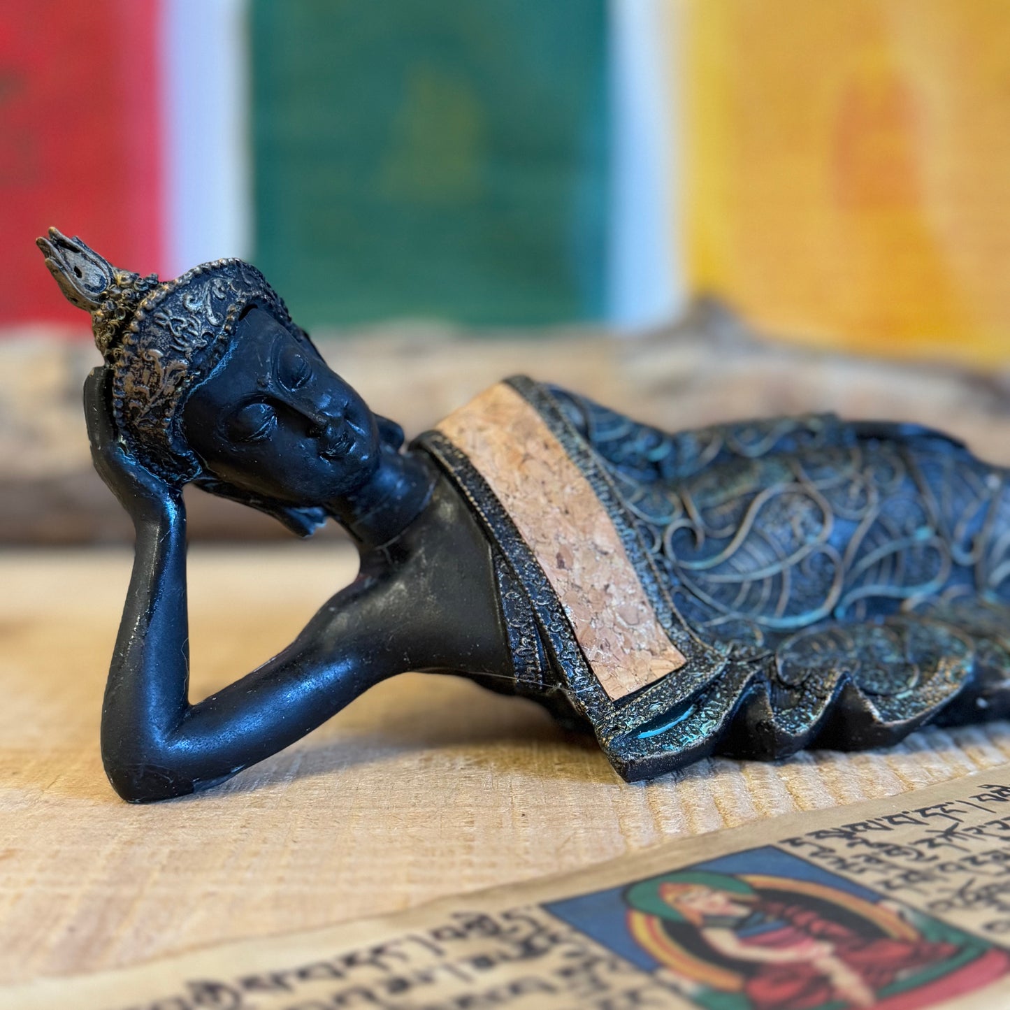 Capture the serene elegance of Buddhist artistry with this exquisite Thai-style reclining Buddha statue. Measuring 36 x 9 x 11 cm and crafted from durable poly resin, this piece combines traditional design with a timeless vintage aesthetic.