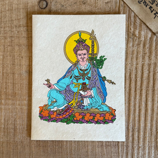 Beautifully coloured and decorated greetings card, made from Lokta paper, featuring Guru Padmasambhav.

Lokta paper making is a traditional practice from the high altitude Himalayan forests of Nepal. The Lokta bush is a fast growing shrub and the paper making process helps to provide economic stability for some of Nepal's poorer rural people.

Size: approx. 15.5 x 11.5 cm

☸Buddhist design Lokta paper card with envelopes
☸Made from a sustainable plant source
☸Handmade and Fairtrade from Nepal