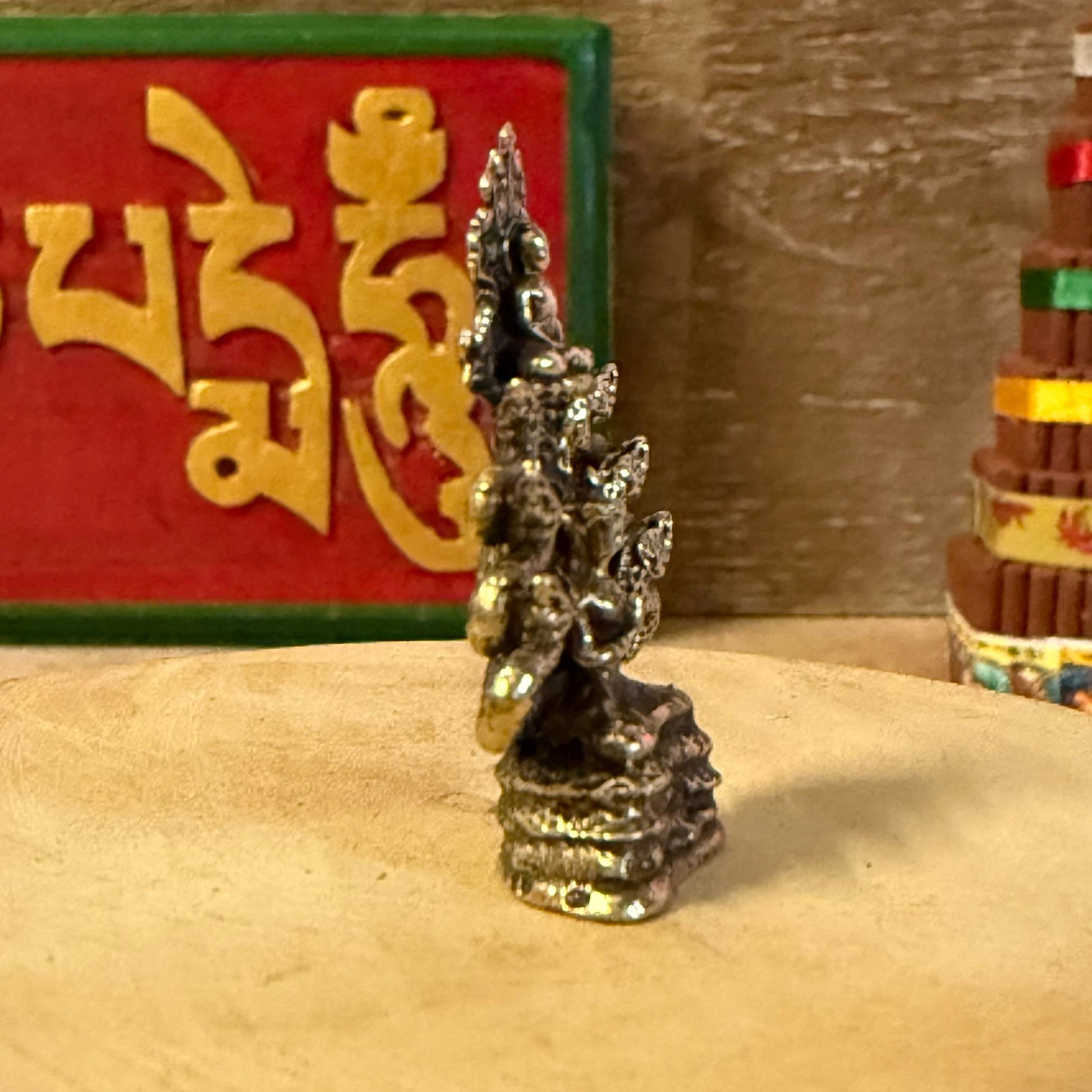 The Mini Brass Buddha with Nagas depicts a sacred moment in Buddhist tradition—when the naga king Mucalinda rose from the waters to shield the meditating Buddha from the storm. This timeless symbol represents divine protection, inner peace, and enlightenment.