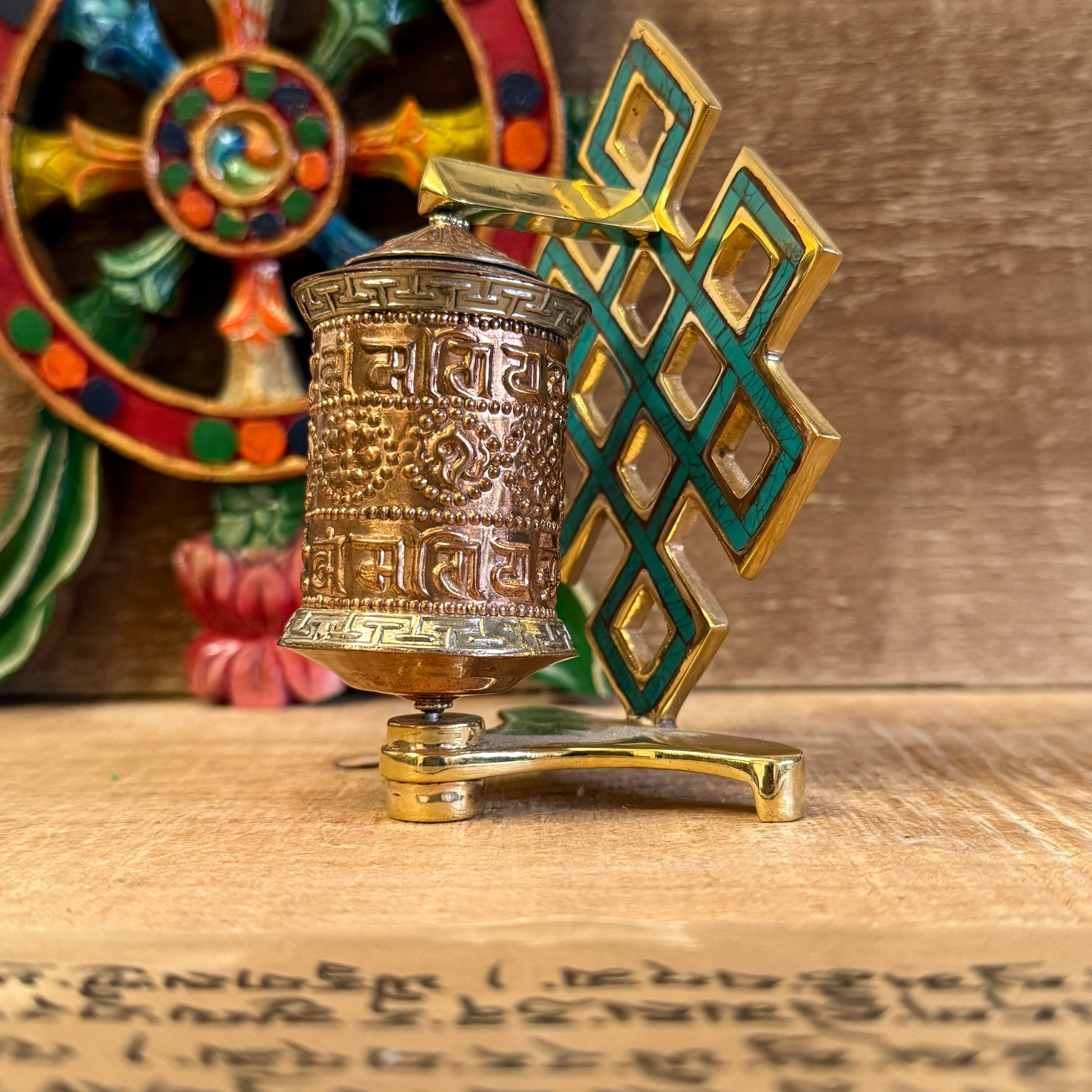 The Endless Knot, painted in a turquoise-green hue, symbolizes the interdependence of all things and the infinite nature of wisdom. Each spin of the copper wheel turns the printed mantras within, radiating blessings and merit in every direction.

A spiritual tool to remind you of the ever-present Dharma, whether in quiet practice or daily life