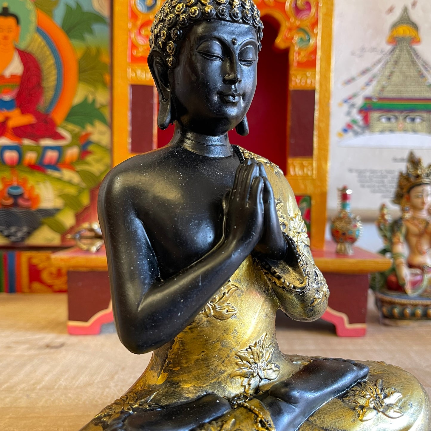 Thai style Buddha with vintage look and praying mudra (hand gesture).  The Anjali mudra is done by placing both hands close to the chest with the palms and fingers joined against each other vertically. It is believed that the enlightened Buddhas do not make this hand gesture because it is mainly for the Bodhisattvas who aim or are preparing to attain enlightenment or perfect knowledge.  Feng Shui Tip: Your main entrance, dining or living room is the right spot to place the Buddha with this mudra.